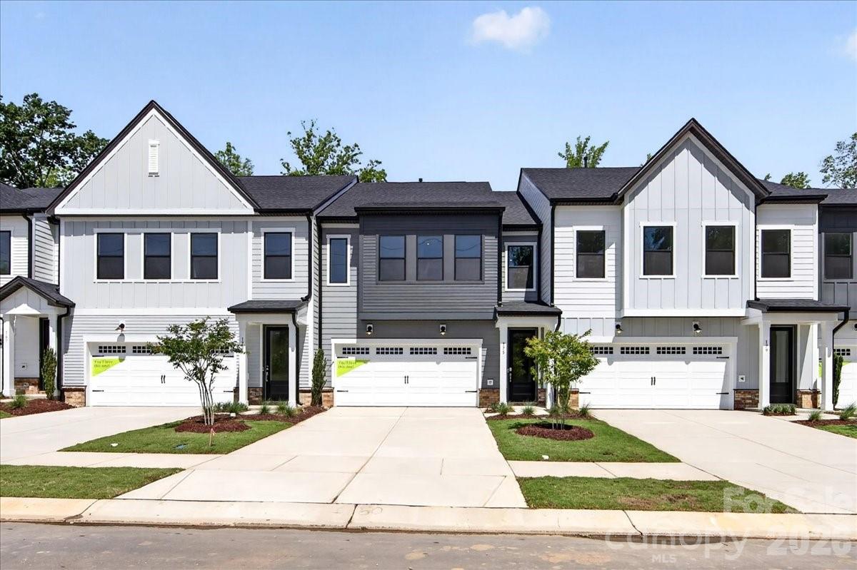 Tucked into Fort Mill's Camryn at Southbridge, this Falcon plan backs up to a wooded area with no neighbors in front or behind,  a level of privacy that's hard to find in a townhome community. Scenic trails, a playground, and quick access to Kingsley Town Center, Anne Springs Close Greenway, and top-rated schools make the location just as appealing as the home itself. Inside, tray ceilings and oak box stairs with open rails make a strong first impression. The gourmet kitchen delivers with white cabinetry, Armor Grey quartz countertops, a Modern Hearth White Ash matte backsplash, under-cabinet lighting, a GE 36" gas cooktop, Delta Essa Touch faucet, and upgraded pantry shelving. A drop zone, and extended outdoor living space round out a layout built for how people actually live. Upstairs, a loft leads to the primary suite with tree views, a tiled walk-in shower in the primary bath, in-closet laundry connection in the primary and tiled walls above the tub in the secondary, all across three bedrooms, two and a half baths, and a two-bay garage with a full-length driveway.