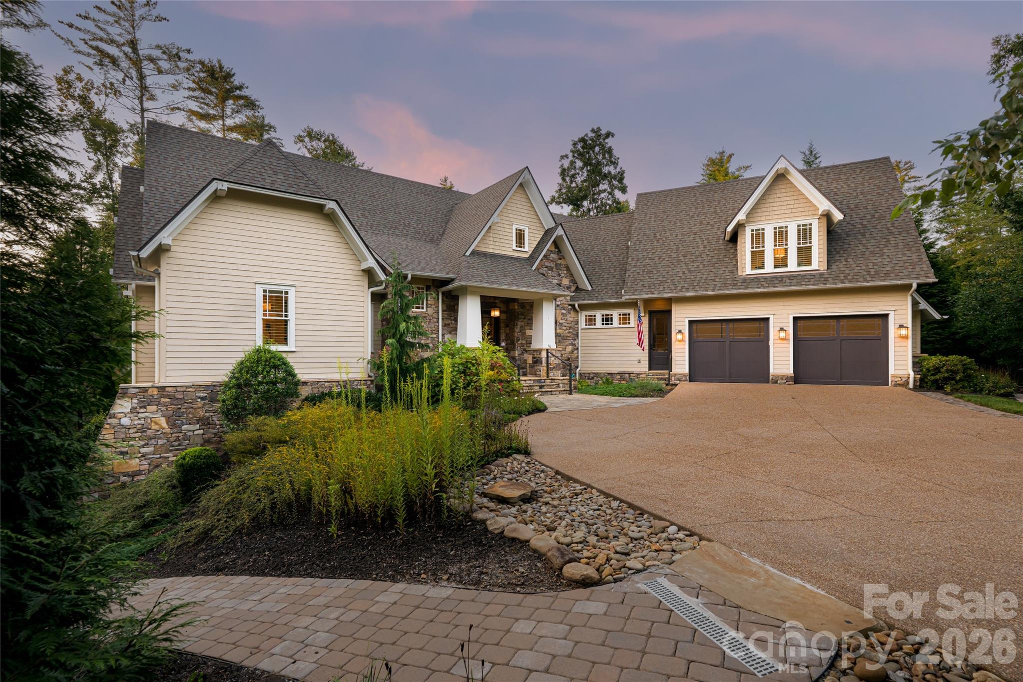 A refined expression of transitional design, this residence blends timeless craftsmanship with modern livability, set against a serene wooded backdrop. Incredible proximity to Longmeadow Park, and overlooking Community green space. An open, light-filled floor plan creates an atmosphere that is sophisticated and inviting, with expansive windows framing protected community land that ensures privacy and a peaceful connection to nature. At the heart of the home, the living room offers a seamless indoor-outdoor dialogue, ideal for quiet moments and gracious entertaining. The gourmet kitchen is equally compelling, appointed with top-tier appliances, custom cabinetry, generous countertops and a spacious walk-in pantry, complemented by a convenient laundry room. A screened-in porch extends the living space year-round, overlooking the tranquil forest and inviting relaxation in every season. A private suite above the two-car garage, complete with a full bath and separate staircase, provides exceptional flexibility for guests, a home office or creative retreat. The terrace level enhances the lifestyle further with a large exercise room suited for wellness or recreation. Ownership includes access to The Ramble’s celebrated amenities such as miles of scenic trails, a wellness center, saline pool, tennis and pickleball courts, and lush parks. An exceptional offering where elegance, ease and natural beauty converge.