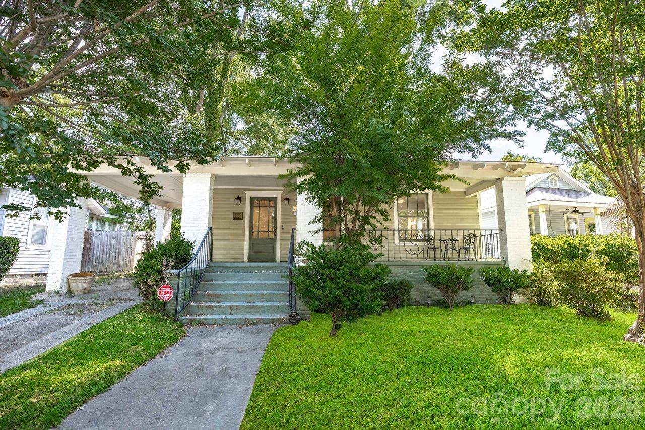 Beautifully restored Historic Elmwood Park bungalow, fully renovated in 2021 with all new plumbing, electrical, and HVAC. Thoughtfully updated with historic preservation in mind, this home seamlessly blends timeless charm with modern conveniences. Features include heart pine floors throughout most of the home, a stunning designer kitchen with high-end appliances, stylish hardware, and exceptional lighting. Spacious primary suite offers a private bath and walk-in closet. Two additional bedrooms share a beautifully updated bath with dual vanities and a tiled shower, plus a convenient half bath for guests. The second bedroom also includes a large walk-in closet. Enjoy outdoor living on the inviting covered front porch or in the fully fenced backyard with a new privacy fence—perfect for relaxing or entertaining.