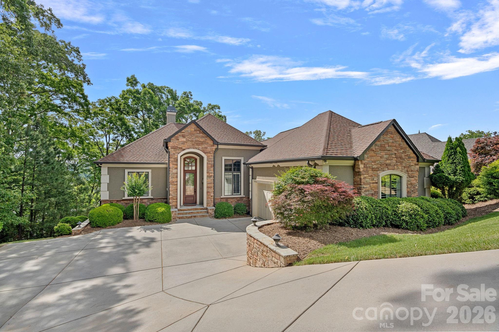 LAKEFRONT LUXURY | BIG WATER VIEWS | ELEVATOR | COVERED DOCK -

Experience the ultimate in luxury waterfront living at this exceptional custom Yeary Homes retreat in the prestigious gated community of Reflection Pointe on Lake Wylie. Perfectly positioned on a deep-water homesite with breathtaking main-channel views, this thoughtfully designed home captures the beauty of the lake from nearly every rear-facing room.

Timeless craftsmanship and elegant finishes define the open-concept floor plan. The dramatic Great Room features soaring 14-foot coffered ceilings, custom built-ins, fireplace, walls of windows, and panoramic water views that immediately command attention. The chef’s kitchen is equally impressive with granite countertops, extensive pull-out cabinetry, new appliances (2024), and seamless flow into the living and dining spaces—perfect for entertaining and everyday living alike.

The luxurious main-level primary suite offers tranquil lake views, a 12-foot tray ceiling, and a spa-inspired bath designed for comfort and relaxation. Elevator access to the lower level provides convenience and flexibility for guests and multigenerational living. Garage was extended to accommodate a motorcycle, so there’s plenty of extra space in the garage. 

The walkout lower level is ideal for entertaining, featuring a spacious secondary Family Room with fireplace, wet bar, screened porch with incredible water views, three additional bedrooms, flex space, and generous storage for lake toys and outdoor gear.

Outdoor living is truly exceptional. Enjoy a flagstone upper terrace, screened lower terrace with tongue-and-groove ceiling, expansive porches, beautifully terraced landscaping, and a lakeside fire pit perfect for sunset evenings. Private waterfront amenities include a covered dock with motorized boat lift, separate floating PWC dock, city water at the shoreline, internet access, dedicated music zone, and HD security camera system. Deep water provides excellent boating access even during lower lake levels.

Additional luxury features include whole-house automation, surround sound, plantation shutters, aluminum-clad windows, tankless water heater, dual HVAC systems, whole-house surge protection, epoxy garage and storage floors, fenced backyard, Zoysia lawn, and lake-fed irrigation.

Tucked within a private wooded setting that feels like a secluded resort, this extraordinary property is conveniently located near Belmont, Charlotte, the airport, dining, and shopping.

The sloped driveway allows the home to sit closer to the shoreline—creating enhanced privacy, spectacular water views, and an immersive lakefront experience rarely found on Lake Wylie. Please see attached feature sheet for the full list of upgrades and amenities.