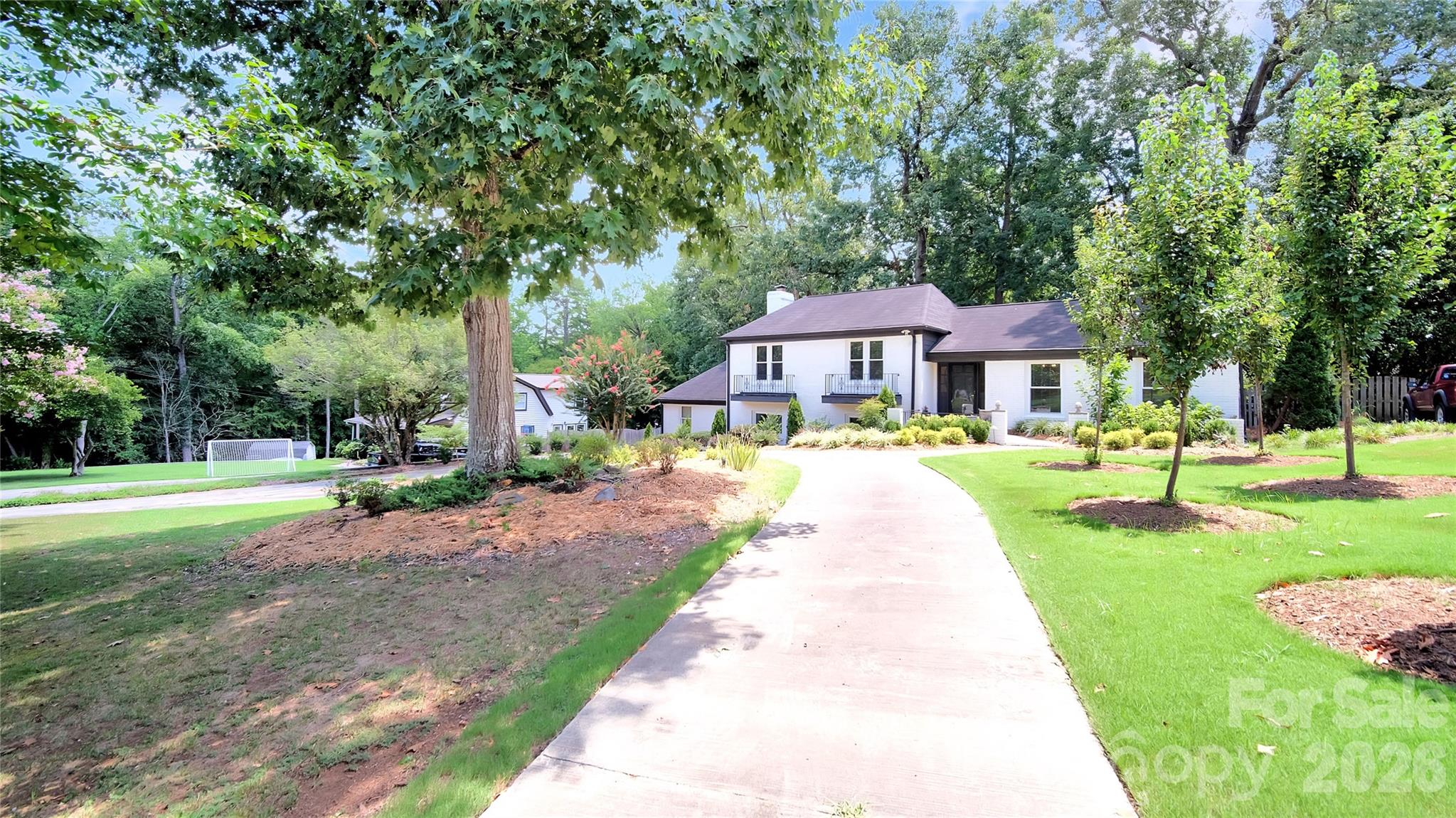 Beautifully updated home featuring major system upgrades and modern interior finishes. The property includes new windows (2026), a new HVAC unit (2023) with a full service, new coolant line, and refill completed in 2026, plus a new water heater (2024). All interior appliances were replaced in 2023, offering reliable, efficient performance throughout the home. Inside, thoughtful improvements elevate every room. The home features new puck lighting and updated fixtures, LVP flooring throughout, and a fully renovated master suite with an expanded bedroom, large walk-in closet, glass shower, soaking tub, smart toilet, smart mirror, and floor-to-ceiling tile. The hall bath also shines with new tile, glass shower, and a smart mirror. The main floor offers an open layout with lofted ceilings, creating a bright, spacious feel. The kitchen has been upgraded with new wood cabinetry and granite countertops, providing both style and durability. Fully renovated kitchen and bathrooms in 2023. Freshly painted exterior in 2026 and new landscaping! Conveniently located to Sardis Country Club, McAlpine Park and Wallace Park with tennis courts, trails, playgrounds and recreation. A short commute to Uptown and South End!