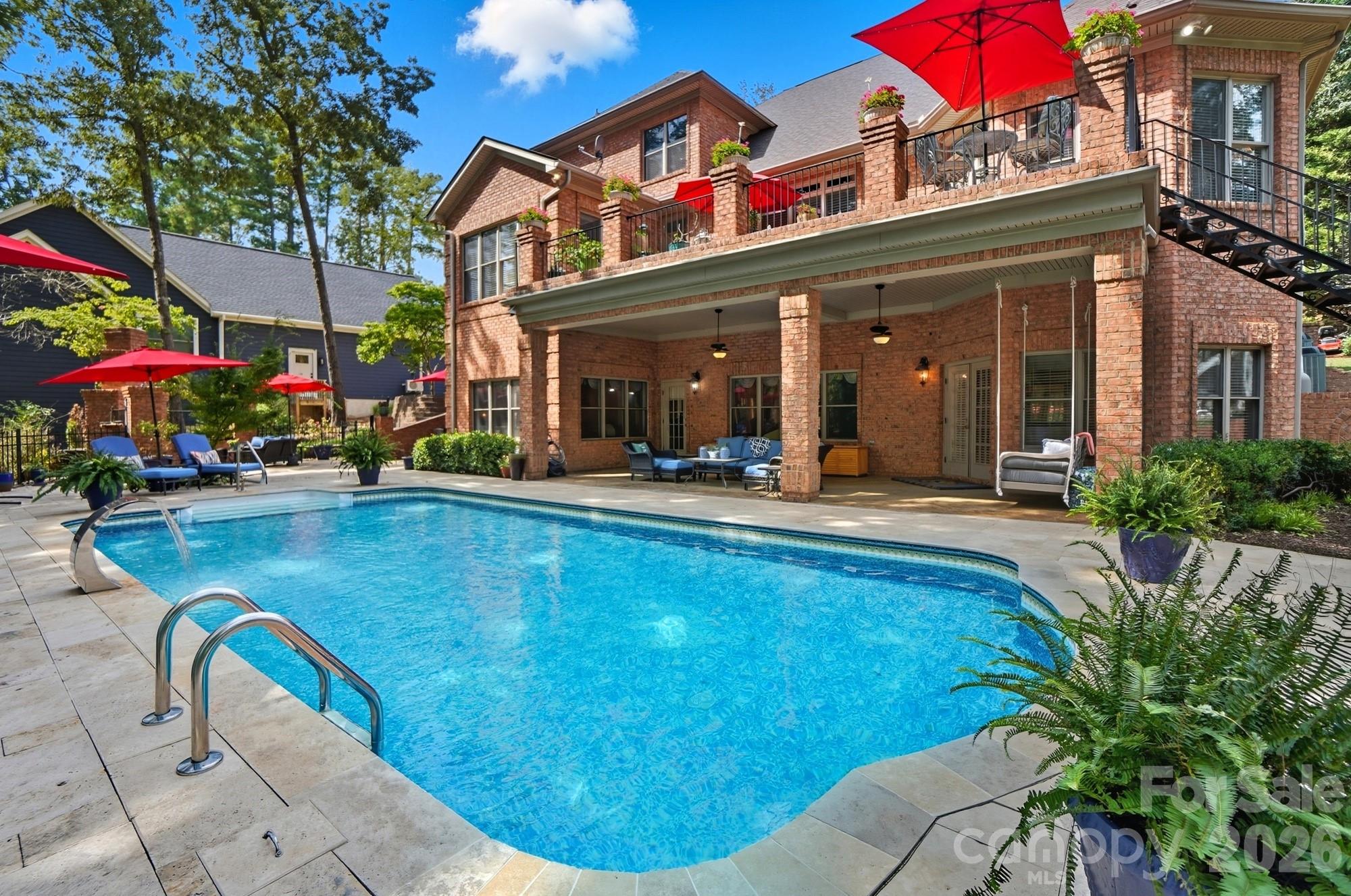 Welcome to 107 Nautilus Court in Troutman—a remarkable waterfront retreat that blends timeless craftsmanship with modern functionality. Built in 2004 and thoughtfully maintained, this all-brick estate is set on a beautifully landscaped 1.16-acre lot, offering both privacy and sophistication. From the moment you arrive, you’ll notice the meticulous attention to detail, from the classic architecture to the lush grounds that frame the home and invite you into a world of serene lake living. The exterior is a true work of art, with every element designed to impress. The second-floor patio features a herringbone brick design that showcases the builder’s craftsmanship, while raw iron steps gracefully descend to the pool area, blending durability with elegance. The swimming pool itself has recently been resurfaced in travertine, creating a timeless backdrop for summer gatherings, relaxing afternoons, or evenings spent entertaining under the stars. Nestled on a quiet cove with deep water, Here, you can soak in peaceful, uninterrupted water views while still being close to everything the lake lifestyle has to offer. Inside, the home continues to impress with thoughtful design and luxurious finishes. Gleaming hardwood floors flow seamlessly throughout the main level and upstairs, adding warmth and continuity, while the finished basement is enhanced with durable tile, combining practicality with style. The home is approved for a four-bedroom septic system but is currently arranged to comfortably accommodate six bedrooms, offering incredible flexibility for family, guests, or multi-generational living. The gourmet kitchen is a chef’s dream, boasting a 48-inch commercial-grade Thermador eight-burner range with a stunning brick backsplash and convenient pot filler. A built-in refrigerator, raised Bosch dishwasher, and expansive prep space make this kitchen as functional as it is beautiful. To complement the main kitchen, the basement features a second full kitchen that rivals the primary one, complete with modern appliances and ample workspace—perfect for secondary living quarters, hosting long-term guests, or creating the ultimate entertainment hub. The home’s layout offers both comfort and versatility. Upstairs, three generously sized bedrooms are accompanied by a spacious bonus room, ideal for a playroom, home office, or media space. The main level is designed for seamless living, with open, airy spaces that transition naturally from one room to the next, while large windows bring in abundant natural light and frame spectacular views of the lake. The basement provides an incredible extension of living space, with its own kitchen, gathering areas, and direct access to the pool and outdoor entertaining areas. Beyond the structure itself, 107 Nautilus Court is about lifestyle. Imagine starting your mornings with coffee on the patio, listening to the gentle sounds of water lapping against the shoreline. Spend your afternoons by the pool or exploring Lake Norman from your own backyard, and end your evenings enjoying the peaceful ambiance of your private cove. With deep water access, you’ll have no shortage of opportunities to launch a boat, entertain friends, or simply relax in the beauty of nature. This property combines style, function, and an enviable location into one extraordinary package. Rarely do homes of this caliber come available—especially with such an ideal blend of craftsmanship, amenities, and waterfront tranquility. 107 Nautilus Court is more than a home; it’s a statement of elegance and a true opportunity to experience the very best of lake living.Home is available FULLY FURNISHED with a reasonable offer.