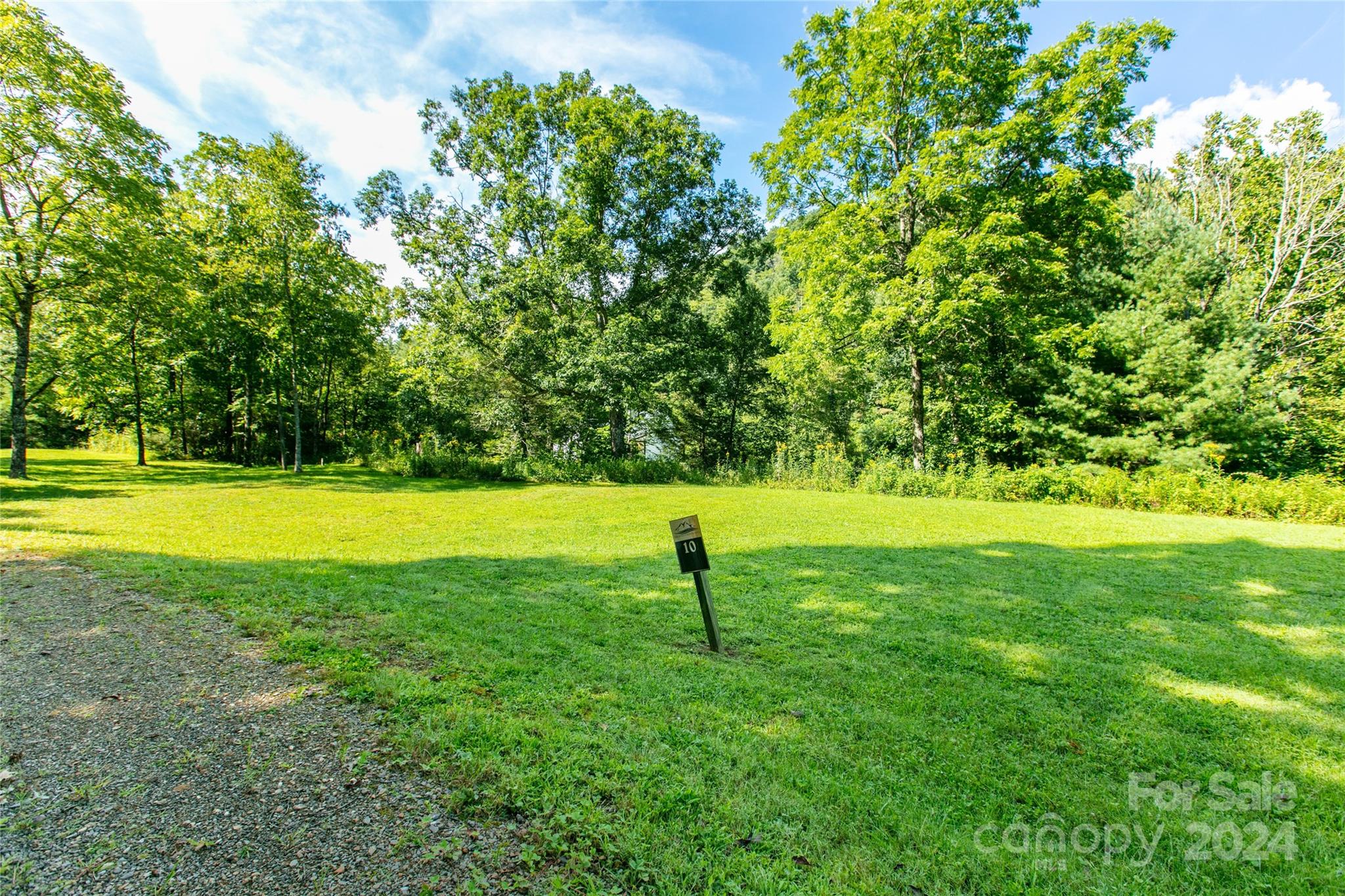 Ready to Build Your Mountain Retreat by the River? Discover a well-maintained and near-level community—a rare gem in the mountains! Immerse yourself in the soothing sounds of water cascading over river rocks, set against the breathtaking backdrop of the national forest and Camp Daniel Boone. Enjoy convenient access to the Blue Ridge Parkway, renowned trout waters perfect for fly fishing, and the locally beloved Sunburst Trout Farm. Whether you're seeking tranquility or adventure, this location offers the best of both worlds.