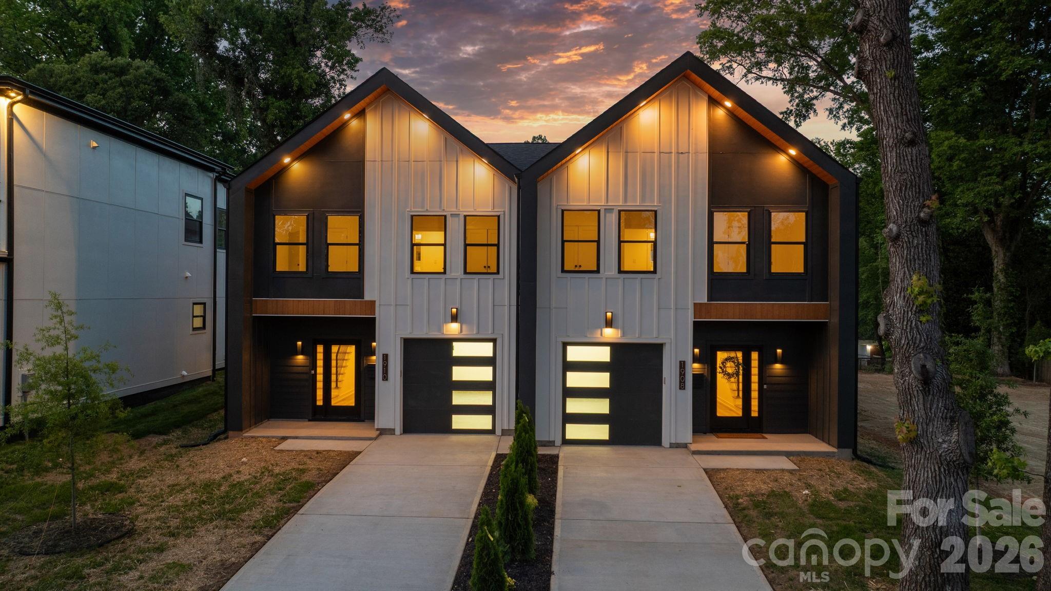 Welcome to a townhome that redefines modern living in Charlotte. Built by Halo Construction in partnership with Nava Builders, this 3-bedroom, 2.5-bath home with a 1-car garage delivers a true wow factor the moment you walk in and finishes you simply don't see in townhomes at this price point.

The kitchen is the showstopper. High-contrast, cabinetry pairs sleek black lowers with crisp light brown oak uppers, topped with 5-tier Panda quartz countertops chosen specifically to add dimension and depth. A custom designer tile backsplash runs to ceiling, framing a gas range and a full suite of black stainless steel appliances, including an LG InstaView refrigerator that lights up with a simple knock on the glass. Every surface in this kitchen was selected with intention, and it shows.

The living area is anchored by a modern electric fireplace, finished with designer lighting throughout and a custom fabricated metal railing that brings an architectural edge to the staircase the kind of detail that elevates the entire home. Even the garage steps it up with hexagonal accent lighting, signaling right away that no space was an afterthought.

Upstairs, the same intentional design carries into the bathrooms: high-end tile that flows seamlessly from the floor straight up into the shower walls, custom closet build-outs, and modern fixtures that tie everything together. On the main level, the half bath features a custom sink another small touch that sets this home apart from the typical new build.

Behind the scenes, the home is built to perform: gas furnace, gas range, and an electric water heater efficient, modern, and ready for the long haul.

Location is everything, and this one delivers. You're 5 minutes from Camp North End, less than 10 minutes to Uptown and South End, close enough to enjoy the best of Charlotte, far enough out to skip the rush hour grind. You're also surrounded by luxury residential properties, including an estate-level home right next door, so the long-term value of this street speaks for itself.

For buyers thinking about multi-generational living or an in-law setup, the full duplex is available a rare opportunity to keep family close without sacrificing privacy.
This townhome doesn't ask you to compromise. Schedule your private showing today.