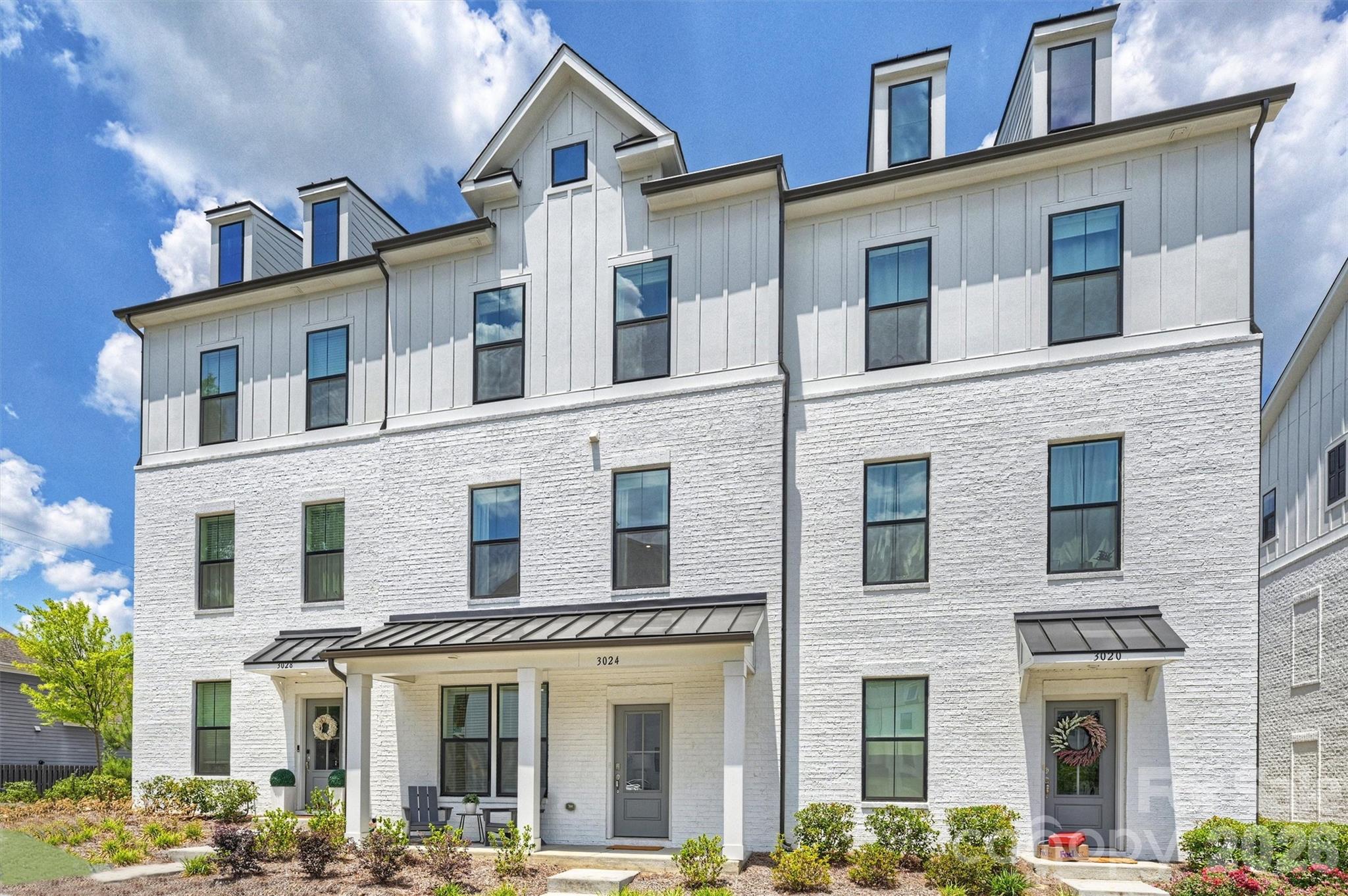 Nestled just steps from Charlotte's beloved Cotswold corridor, this stunning three-story townhome blends board-and-batten craftsmanship with painted-brick charm. Dormer windows, slate-tone rooflines, and a metal-accented covered porch frame a home that feels both timeless and contemporary. This beautifully curated, nearly new residence offers refined design, effortless entertaining, and an unbeatable location. Ideally positioned overlooking the community park, the home captures a rare combination of privacy, charm, and connectivity. 

One of the largest floor plans in the community, the thoughtfully designed layout offers remarkable flexibility with expansive living spaces, generously sized bedrooms, and designer finishes throughout. The entry level features a private guest suite or dedicated home office with full bath access—ideal for guests, multigenerational living, or a quiet workspace—along with an oversized rear-load two-car garage and storage. The main level is filled with natural light and showcases soaring ceilings, oversized windows, luxury flooring, and curated lighting. The chef’s kitchen is a true centerpiece, featuring quartz countertops, designer cabinetry, an oversized island, stainless steel appliances, a wall oven, a cooktop with statement hood, tile backsplash, and a spacious pantry. The kitchen flows seamlessly into the dining area and expansive living room, while large glass doors open to a private terrace. The upper level offers a serene primary retreat with a spa-inspired bath featuring dual vanities, designer tile, a walk-in shower with bench seating, and a spacious walk-in closet. Additional bedrooms are well-appointed and complemented by a large secondary bath and ample storage. Water, trash service, and lawn maintenance are all included in the HOA, offering added convenience and low-maintenance living.

Ideally located just minutes from SouthPark, South End, Myers Park, Uptown Charlotte, Montford Drive, and Cotswold Village, this home offers convenient access to premier dining, shopping, fitness, and entertainment. With HOA-covered lawn maintenance, water, sewer, and trash services, this is luxury low-maintenance living at its finest.