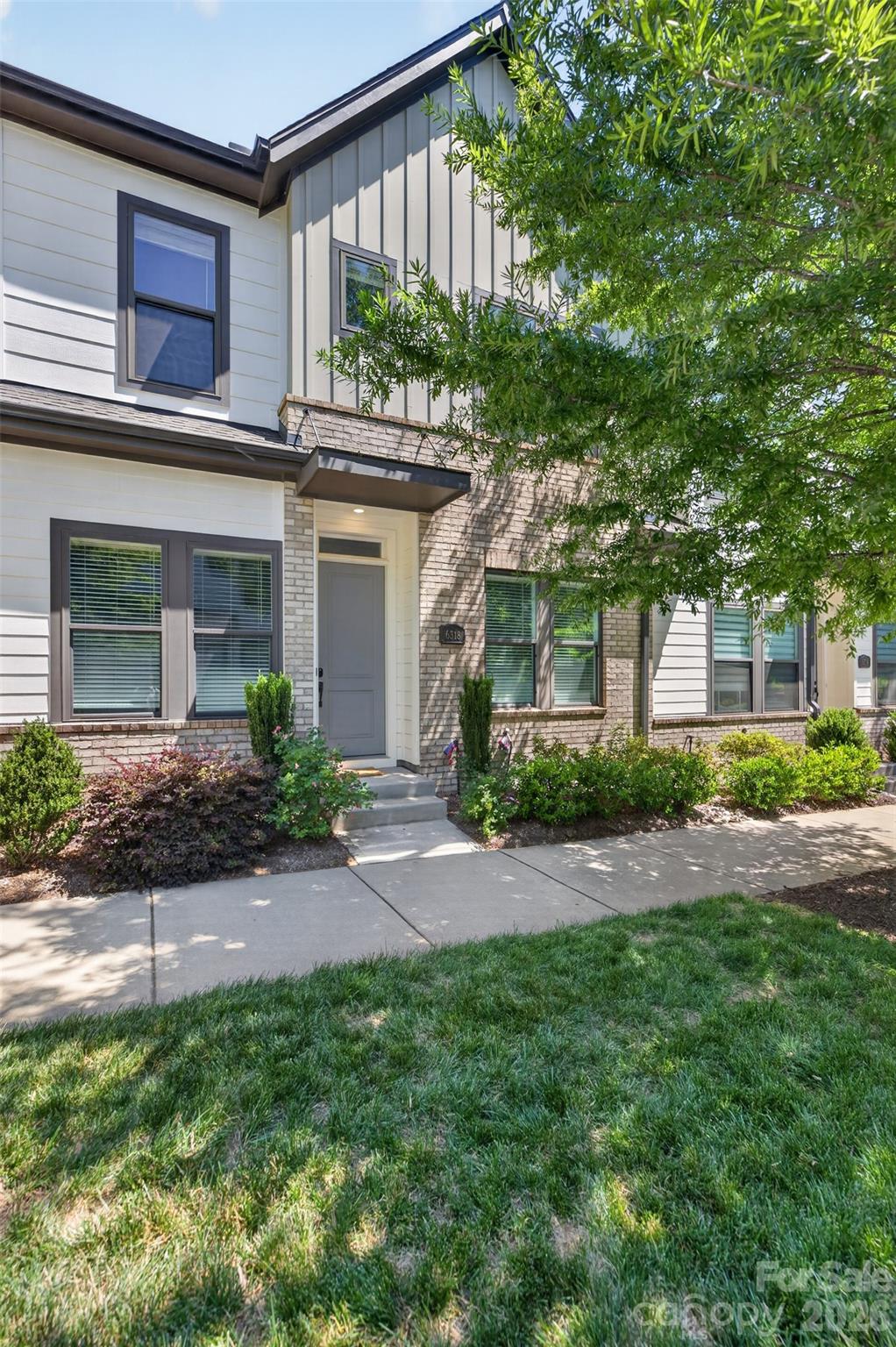 Gorgeous David Weekley townhouse in Waverly. Sought after floor plan with living areas on the main floor, bedrooms on the second floor, along with laundry + flex space w/full bath on the third floor. This house features specialty upgraded lighting throughout, waterfall cabinets in the kitchen, quartz counters, tile backsplash and gas range. Newly installed wood flooring throughout the second floor, big laundry room w/tile flooring, plus oversized primary suite featuring double sinks, seamless shower and huge walk in closet. The third floor flex space can be a large family room, a guest suite (has a full bath),  multi media space, office etc.  Convenient parking between Whole Foods and this townhouse, plus the spaces behind the building, where the oversized 2 garage is accessed. Ideally located in Waverly, arguably one of the biggest hubs in South Charlotte. Imagine walking to Starbucks for coffee, then grabbing groceries at Whole Foods on the way home. Don't feel like cooking? No problem, Foxcroft Wine, Co, Yama or The Porters House offers a bit more upscale dining to Chipotle, Chic Fil A, or Viva Chicken for grab and go meals. Later you can walk to the terrace and grab a Hagen Daaz or walk to Lifetime or Corepower Yoga  to workout. This is the perfect blend of walkable living without sacrificing the creature comforts of an upscale luxury home.