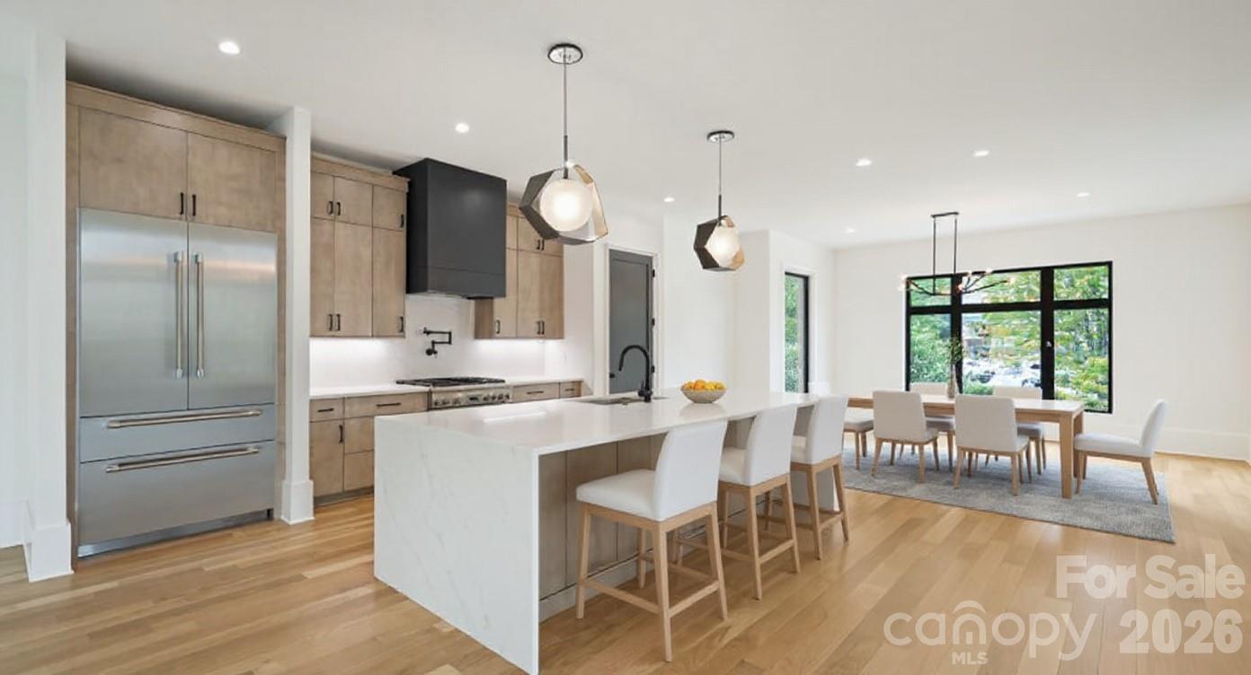 Brand-new modern 4-story townhome in coveted Dilworth, walkable to Latta Park, St. Patrick's, Atrium Main, all shopping/dining on East Blvd & the Sugar Creek Greenway. Spanning 4,022 sqft., this residence features 10’ ceilings, 8’ doors, blonde white oak hardwoods, and a private elevator to all levels, including the expansive rooftop terrace. The chef’s kitchen boasts custom cabinetry, Thermador appliances, waterfall-edge island, gas range/pot filler & French-door refrigerator. The primary suite offers a spa-like bath with soaking tub, rain shower, sleek tile, water closet & custom walk-in closet. Each ensuite bedroom is finished with custom tile. The versatile third level includes a full bath and open living space that is roughed in for an entertainment bar, and separate room ideal for an office, lounge, or 4th bedroom. Additional highlights include a laundry room with sink & side-by-side space and abundant natural light. A rare opportunity to own a luxury new construction home in Charlotte’s premier neighborhood. Easy access to 77, 85, and the airport.