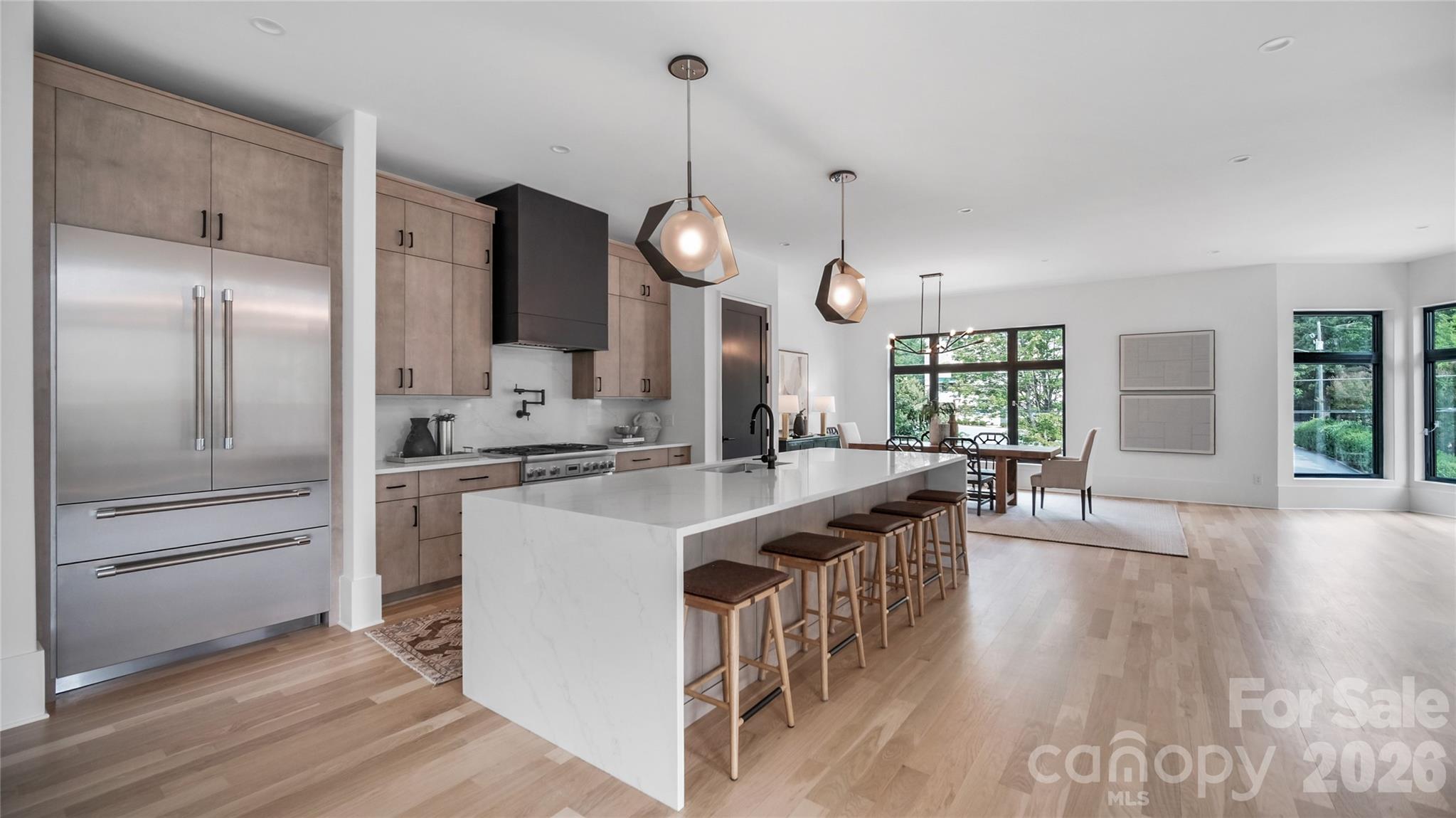 Brand-new modern 4-story townhome in coveted Dilworth, walkable to Latta Park, St. Patrick's, Atrium Main, all shopping/dining on East Blvd & the Sugar Creek Greenway. Spanning 4,022 sqft., this residence features 10’ ceilings, 8’ doors, blonde white oak hardwoods, and a private elevator to all levels, including the expansive rooftop terrace. The chef’s kitchen boasts custom cabinetry, Thermador appliances, waterfall-edge island, gas range/pot filler & French-door refrigerator. The primary suite offers a spa-like bath with soaking tub, rain shower, sleek tile, water closet & custom walk-in closet. Each ensuite bedroom is finished with custom tile. The versatile third level includes a full bath and open living space that is roughed in for an entertainment bar, and separate room ideal for an office, lounge, or 4th bedroom. Additional highlights include a laundry room with sink & side-by-side space and abundant natural light. A rare opportunity to own a luxury new construction home in Charlotte’s premier neighborhood. Easy access to 77, 85, and the airport.
