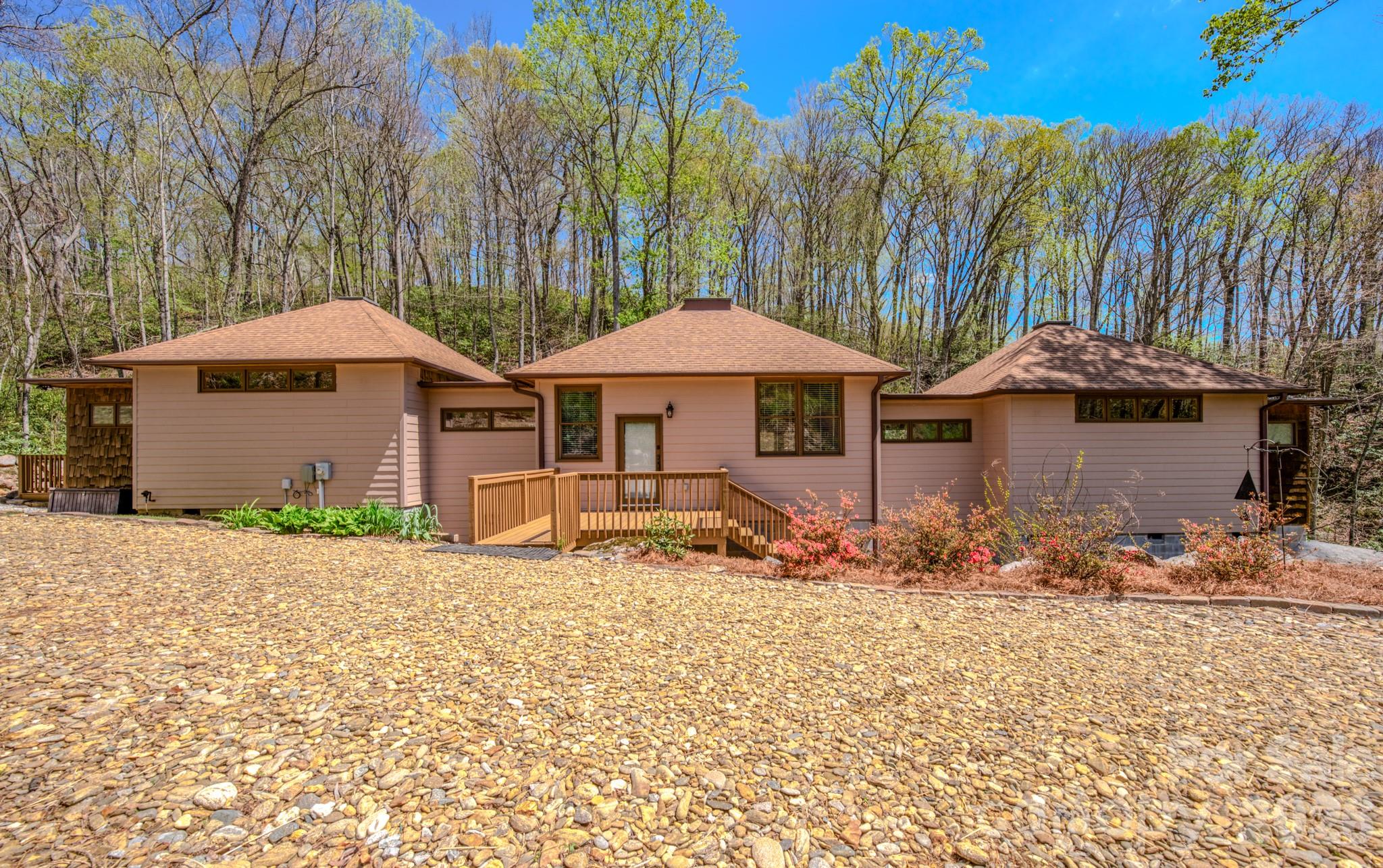 Escape to the quiet beauty of the mountains with this thoughtfully designed retreat, where peace and relaxation take center stage. Nestled in the serene landscape of Bakersville, this 2 bedroom, 2.5 bath home offers a perfect balance of comfort, privacy, and natural charm.

Inside, the inviting living space is complemented by warm wormy maple kitchen cabinetry and custom built-in benches with hidden storage blending functionality with timeless mountain character. Large windows invite the outdoors in, allowing you to take in views of the gently flowing creek while also hearing its soothing sounds from within the home creating a truly immersive, calming environment.

Outdoors is where this property truly shines! Three spacious independent private decks overlook the tranquil creek, offering the perfect setting for morning coffee, quiet reflection, or evening relaxation. A propane gas hookup makes outdoor dining effortless, while the warm-water exterior hookup provides the opportunity to create a spa-like outdoor shower experience.

A private walking trail runs alongside the creek, inviting you to stroll, unwind, and fully connect with the natural surroundings. The river rock driveway enhances the home’s organic beauty, welcoming you into a setting that feels both grounded and refined.

Whether you are seeking a weekend sanctuary or a place to fully disconnect and recharge, this property offers a rare opportunity to embrace the restorative beauty and peaceful rhythm of mountain living.