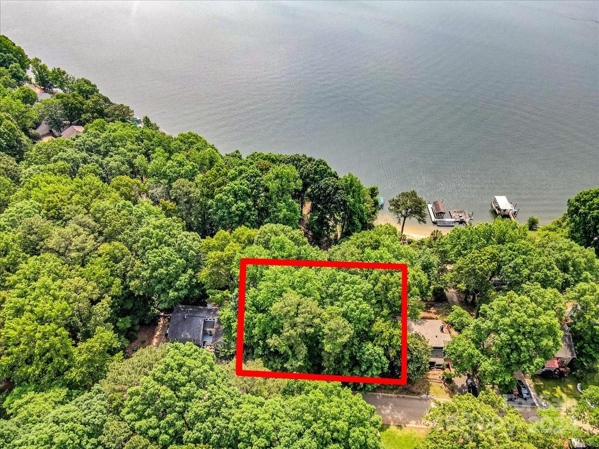 Discover the perfect opportunity to build your dream home on this beautiful lot just steps away from Lake Wylie. This prime location offers stunning views and is only a short drive from the Tega Cay Marina and Golf Club, providing endless possibilities for recreation and relaxation. Embrace the tranquility and charm of lake life in a community that offers the best of both nature and convenience.