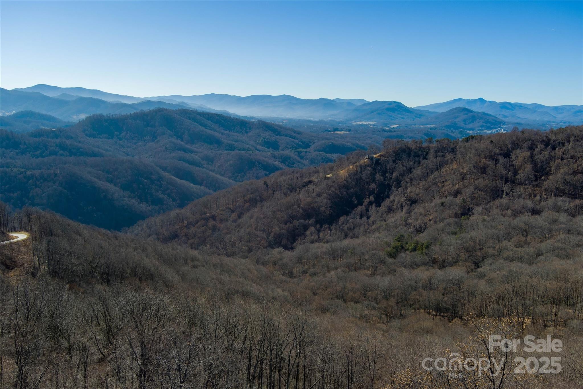 Take in sweeping, year-round long-range mountain views from this beautiful 10.03-acre lot in the gated community of The Summit of Asheville. Sitting at roughly 3,500 feet in elevation on paved Summit View Drive, this property offers something truly special — stunning views to both the east and west, so you can enjoy peaceful sunrises in the morning and unforgettable sunsets in the evening.

The lot already has paved access, underground electric, phone, and fiber internet in place, making it easy to start planning your mountain home. There are several great spots to build depending on the lifestyle you want. Build higher up for big, open views, or tuck in lower on the property for a more private, peaceful mountain retreat.

The Summit of Asheville is a quiet, newly developed community, all at least 10 acres, which keeps things spacious and private. Residents enjoy a community garden, hiking and horseback riding trails, mountain streams, and frequent wildlife sightings. Each lot allows up to three structures, making it a great option for a family compound, or a vacation home. Lots cannot be subdivided, helping preserve the natural beauty and long-term value of the community. A well and septic system will be needed.

You’ll feel worlds away from the noise and traffic, yet you’re still conveniently located — about 20 minutes to downtown Asheville, 25 minutes to Waynesville, close to I-40, and roughly 20 minutes to Asheville Regional Airport.

If you’ve been searching for a mountain property that truly feels special — with space, views, and privacy — this one is worth seeing in person. Contact listing agent for more details!