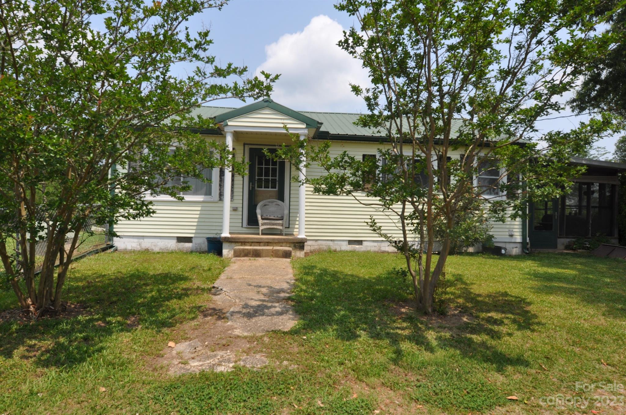 Private 2 Bedroom 2 bath Farmhouse on 12 secluded acres.  Kitchen has a true farmhouse sink with window views of a beautiful Magnolia Tree and the pasture.  Original hardwood floors in the living room and both bedrooms.  Both bedrooms have private baths. Master bath has a farmhouse vanity/sink and shower only.  Home has a propane heater as well for those chilly nights.  Enclosed covered patio for relaxation.  Several barb wired pastures.  Two wells on the property. 2160 square foot barn with 5 stables, tac room, wash room and plenty of room for more stalls.  Stalls have exiting doors as well. Lean too off the side of the barn. Barn has electricity and water.  Chicken coop in an enclosed area.  Large open pasture with a small pond. Wired storage building with two lofts and a side lean too. Peach and pear trees on the property along with several great spots for a garden.  Bring the horses, chickens, goats and the atvs. Convenient to Columbia and Charlotte.