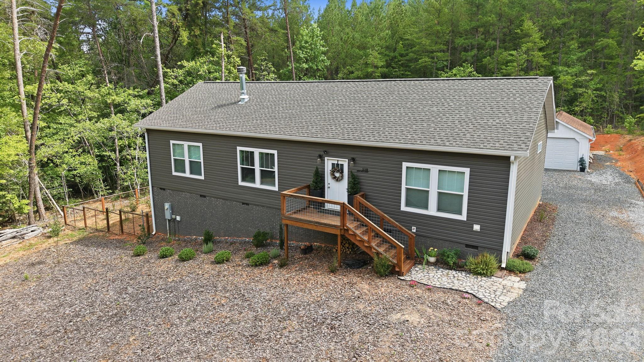 Calling all lake lovers and outdoor enthusiasts!! Welcome to your own Lake Tillery retreat in the gated Carolina Forest community. Built in 2024, this nearly new 3-bedroom, 2-bath home offers the perfect blend of modern comfort, outdoor living, and peaceful surroundings. Step inside to discover a bright, open floor plan with stylish yet timeless finishes throughout, creating a warm and welcoming space that feels like home from the moment you arrive. The spacious owner's suite is truly magical, featuring a stunning spa-like bathroom and generous proportions that make it the perfect place to unwind at the end of the day. Outside, you'll love the spacious rear deck, perfect for morning coffee, evening gatherings, or simply relaxing and taking in the natural beauty and wildlife that surrounds you. A detached garage, fenced backyard, and versatile lot provide plenty of room for hobbies, pets, gardening, or outdoor entertaining. Residents of Carolina Forest enjoy an impressive lineup of amenities, including a clubhouse, community pool, tennis and pickleball courts, marina, boat launch, lake access, and scenic walking trails. Outdoor enthusiasts will appreciate being surrounded by the natural beauty of the Uwharrie National Forest, with endless opportunities for hiking, boating, fishing, kayaking, and exploring nearby. Despite its peaceful setting, everyday conveniences are never far away. Restaurants, grocery stores, fitness centers, and other essentials are just a short drive away, and cities like Charlotte, Greensboro, and Raleigh are within easy reach. If you've been searching for a place where lake life, nature, and modern comfort come together, this Carolina Forest gem is ready to welcome you home!