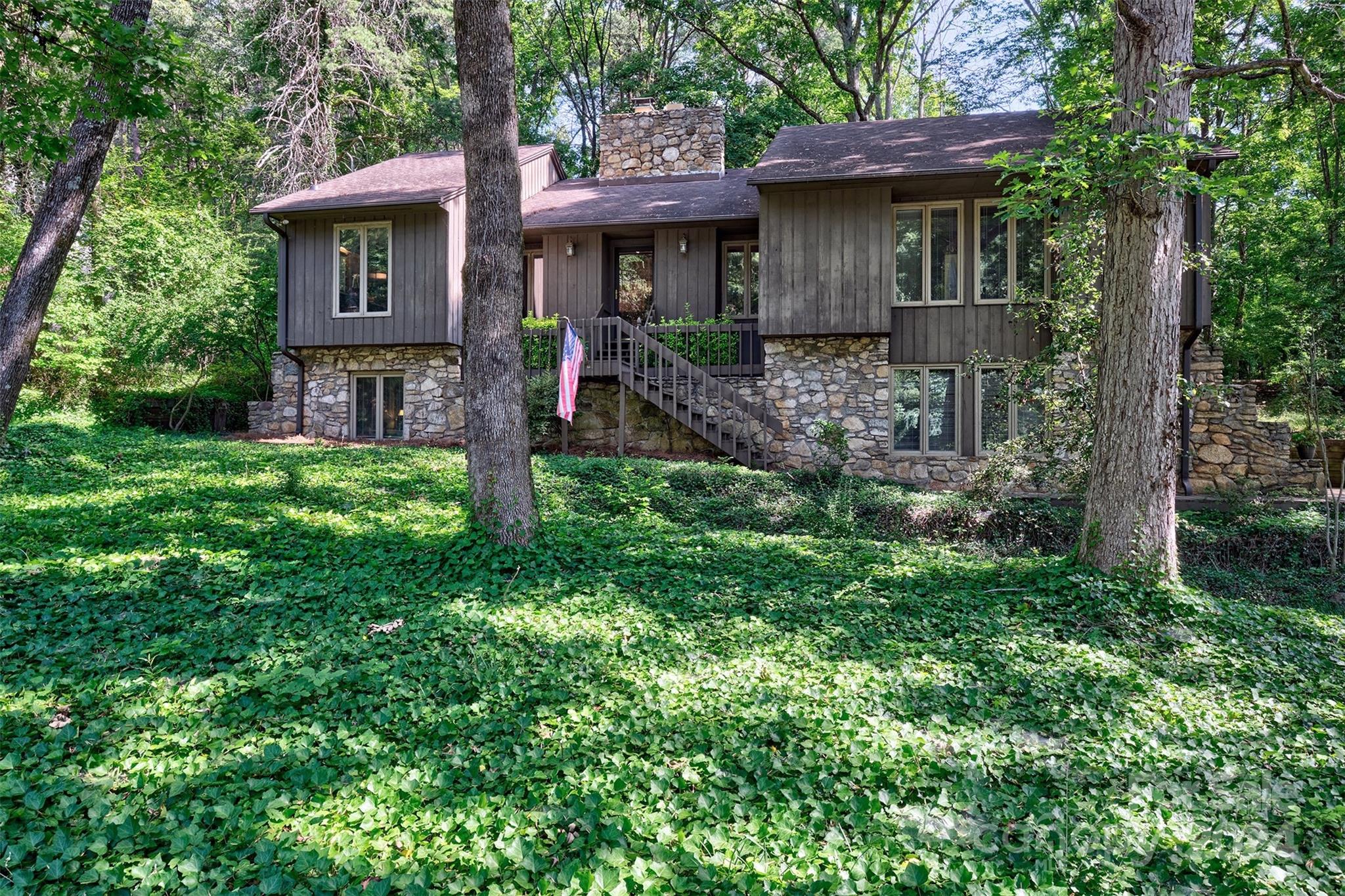Rustic 4 or 5 bedroom home in the gated waterfront and golf community of River Hills on Lake Wylie!The stone fireplace,sourced from a local quarry, is the statement piece for upstairs and downstairs the stone bar pops!Home has so many possibilities for buyers to make it their own with updates and remodels.Primary bedroom &2 more bedrooms are on the top floor along w/ formal dining room,great room with cathedral ceilings ,laundry,eat in area and kitchen The Kitchen features stainless appliances and double ovens for those big holiday dinners and lots of counter space. The basement offers 2 bedrooms/office, huge bonus room with pool table, additional fireplace, full bath and long stone bar to complete the living space. This home would be great for multi generational living with separate entrance and easily added kitchenette. This house offers a mountain home vibe with the open beams and natural setting. Low maintenance yard! Bring your vision and ideas or just enjoy the neighborhood!