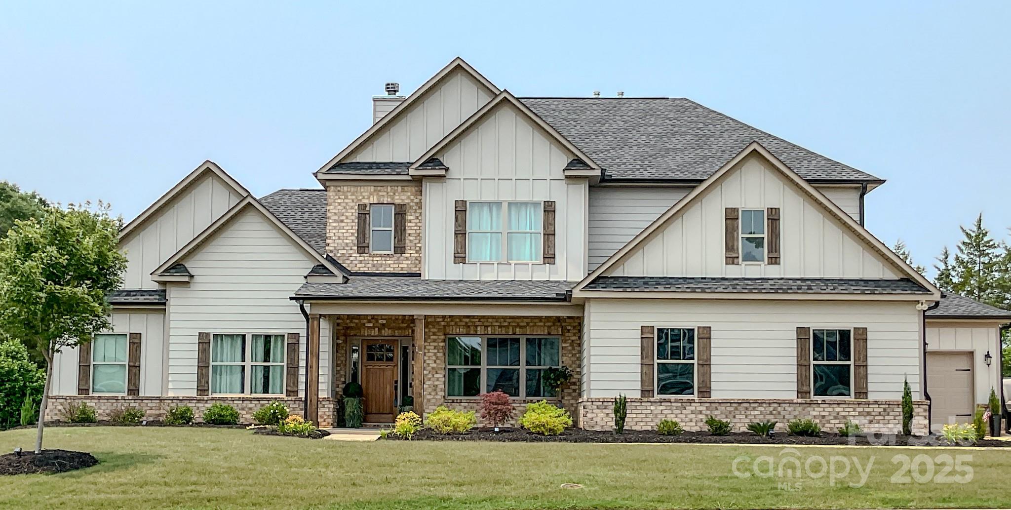 Custom-built in 2024 as the builder’s personal home, this 4BR/5BA Simpsonville residence offers nearly 4,000 sq ft of luxury living. Each bedroom and the office includes a private ensuite bath and walk-in closet. The chef’s kitchen features LG appliances, granite, a walk-in pantry with wine storage, and a butler’s pantry to the formal dining room. Enjoy a spacious great room with coffered ceilings and a wood-burning fireplace. The primary suite includes dual vanities, spa-style shower, bidet, and large walk-in closet. Additional highlights: media room/gym, luxury vinyl flooring, smart thermostats, tankless water heater, and generator-ready panel. Covered patio overlooks a landscaped yard and treeline. Across from Bells Crossing Elementary, zoned for Hillcrest schools, and minutes from Five Forks & I-385. Quiet, fully built-out community with fewer than 30 homes. Move-in ready!