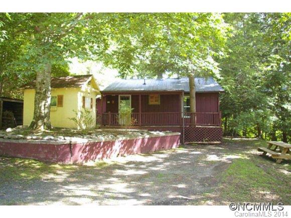 Charming, well-kept home on 3+ acres is private yet totally convenient to town! Spacious rooms, eat-in country kitchen w/tile counters & comfy living room w/fireplace & oversized windows. Maple, cherry, & heart pine floors, tiled bath. Lots of storage! Two Lg. porches for mtn views.  Shady yard fenced. Full basement has inside & outside entrances, wood stove, utility area & a root cellar! Large shed for wood,level yard & fenced garden spot.