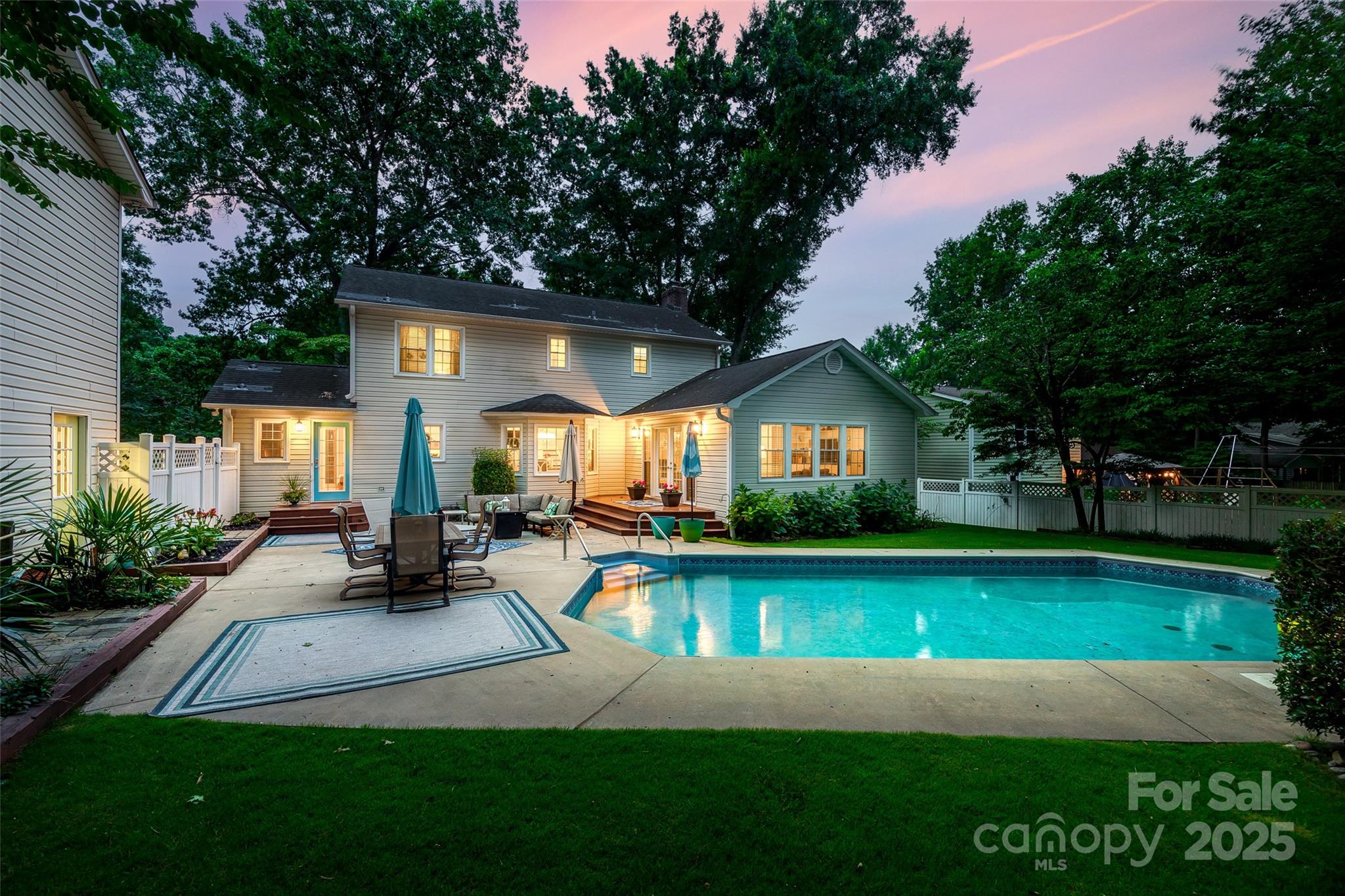 A backyard oasis awaits you in this gem of a home near downtown Fort Mill! At over 1/2 acre & nestled in a private backdrop, you'll find a saltwater pool surrounded by entertaining areas & trex decking. A wrap around front porch greets you & welcomes you in on gleaming hardwood floors. The kitchen has been completely updated, w/ quartz counters, glass subway tile backsplash, gas cooking, & SS appliances. The cozy great room is centered by a fireplace & opens to the sunroom looking out onto the pool. A dining area, office, gorgeous half bath, & laundry room w/ cabinets (w/d are included) round out the downstairs. As you head upstairs you'll find a generous primary suite w/ remodeled bathroom, & 2 additional bedrooms w/ a stunning bathroom - no expense was spared updating this showstopper of a home! The large detached garage has a walk up attic w/ tons of extra storage (over 700 sqft!). Located in the highly rated Fort Mill School District, & w/ low SC taxes, you don't want to miss this!