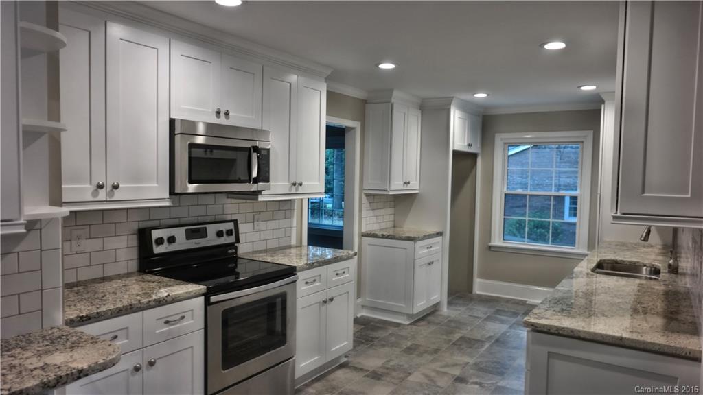 Sprawling ranch home featuring 4bd/3ba w/ over 2500sqft.  Completely remodeled and move in ready, this beauty features a custom built kitchen w/ stainless appliances, granite counters, tile backsplash & pantry.  With 2 master suites to choose from it simply comes down to which custom bath you prefer.  Both are top of the line!  Large secondary bedrooms.  Refinished original hardwoods.  Two fireplaces.  Large sitting area overlooking the sunroom/deck area. Formal living room.  Too much to list!