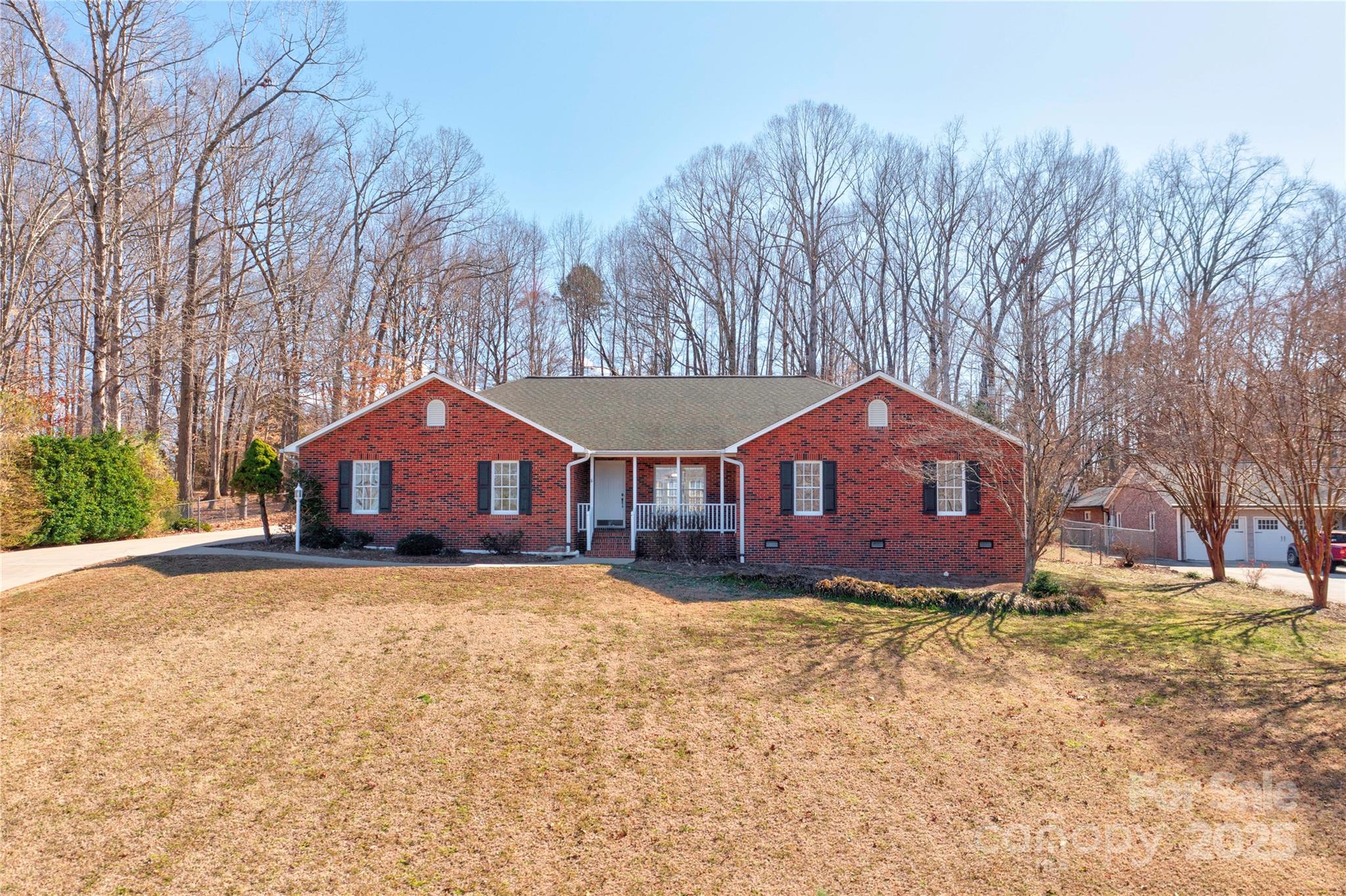 This property features a full-brick home with 3 bedrooms and 3 bathrooms. Two of which are ensuites.  It offers  lake views and is conveniently located. The open floor plan includes a sunroom, a spacious kitchen with plenty of cabinets, and an oversized laundry room with double pantries for ample storage. Additional features include an attached double garage, a rear concrete patio with gas grill connection, and an extra garage/workshop, fireplace with gas logs and built ins, and lots of concrete parking.  So much potential, call before it is gone!  Buyers agents welcome!