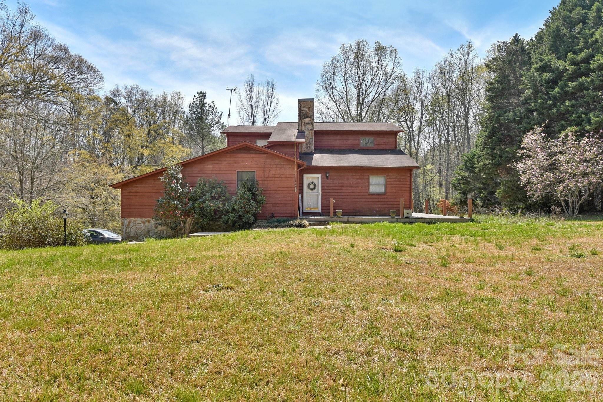 Instant Equity in this home now priced under appraised value. Also, add that it is less than 25 minutes to Charlotte and just a few minutes from the Mountain Island Park Trails! Tucked away on 1.26 acres, this inviting 4-bedroom, 3-bathroom home offers the perfect blend of space, character, and natural surroundings! The living room makes an immediate impression with vaulted ceilings, exposed wood beams, and a stunning stone-surround fireplace that creates a warm, cozy focal point.

The kitchen is complemented by a huge walk-in pantry, providing ample storage and functionality for everyday living. Generously sized bedrooms offer flexibility and comfort, while the unfinished basement adds even more room for storage or future possibilities.

Enjoy the peaceful setting from the wraparound porch, ideal for relaxing or taking in the views of the nearby creek. An additional storage building adds convenience for tools, hobbies, or outdoor equipment. A unique opportunity to enjoy privacy, charm, and room to spread out—all in one beautiful property!