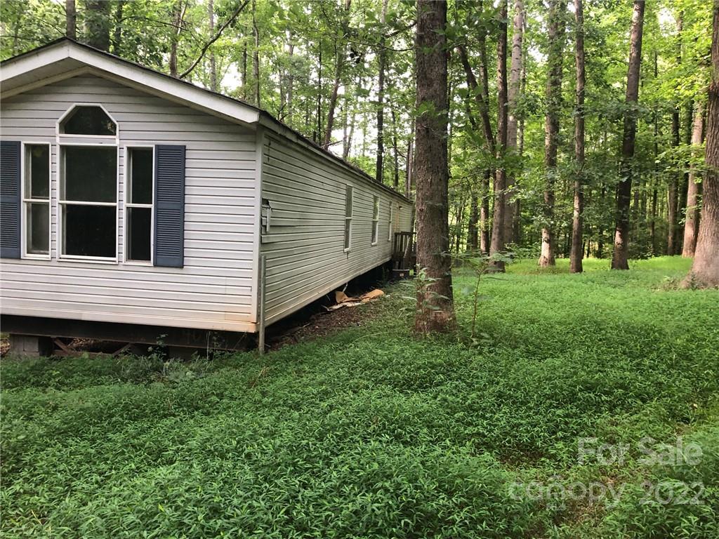 *CASH ONLY* Investors always welcome, home has had some repairs made but the bulk of the repairs will need to be finished. Almost 3 acres heavily wooded lot, in a nice area. Well and septic tank are in place, seller makes no representation regarding the well or septic, please confirm for yourself that the well and septic work as you need it to. Home to be sold as is, age is unknown and 1980 is an estimate. Clover School District