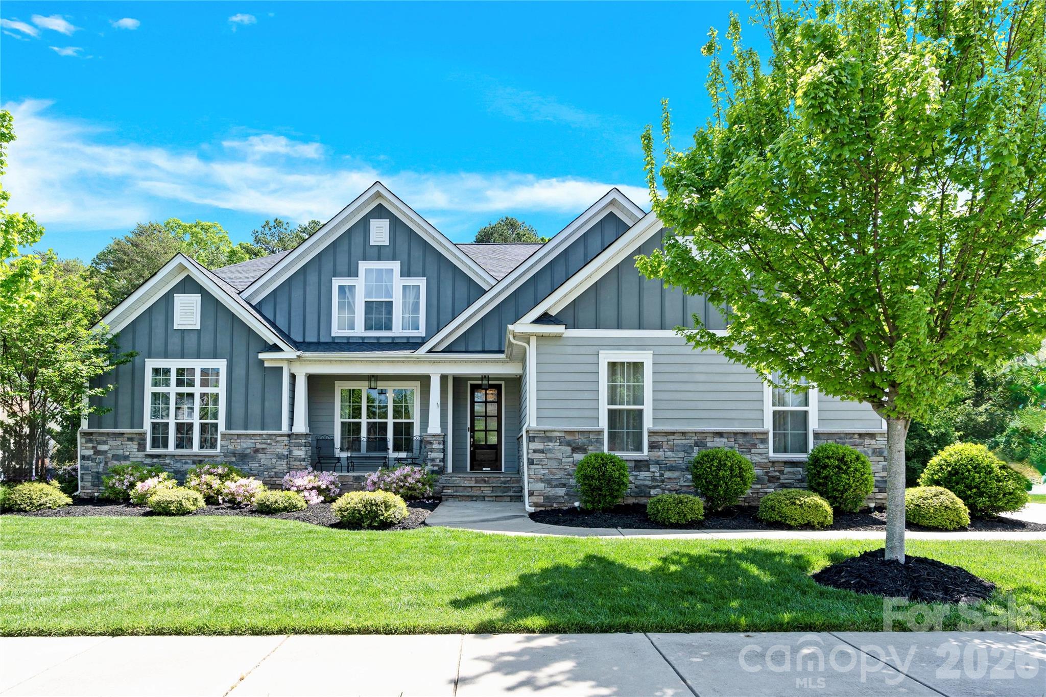 Located in the highly desirable Enclave at Massey, this thoughtfully designed home offers the rare combination of three bedrooms on the main level, a spacious upstairs retreat with an additional bedroom and bonus room, and a side-load three-car garage — all set against a private wooded backdrop within one of Fort Mill’s most sought-after communities.
Welcome to a refined retreat where elevated finishes, functional design, and everyday comfort come together. Situated on nearly 0.3 acres, the fenced backyard backs to a natural wooded buffer, creating a sense of privacy that’s increasingly hard to find within a neighborhood setting.
The main level is both elevated and practical, anchored by a well-appointed kitchen featuring a large island with built-in beverage refrigerator, gas cooktop, and stainless steel appliances. The open-concept design flows effortlessly into the living and dining areas, creating an inviting space for both entertaining and everyday living.
A standout feature of the home is the highly functional main-level layout, offering three bedrooms, two full bathrooms, and a dedicated office — ideal for guests, multi-generational living, or working from home without compromise.
Upstairs expands the living space with an additional bedroom, full bathroom, and bonus room complete with surround sound — perfect for a media room, play space, guest suite, or secondary living area.
Outdoor living is equally inviting, with a covered screened porch featuring a fireplace and views of the private backyard — an easy extension of the home year-round. Modern conveniences include a Tesla charger and smart home camera system.
Residents of Enclave at Massey enjoy resort-style amenities including a pool with lazy river and slide, clubhouse, fitness center, and playground, all while being zoned for highly regarded Fort Mill schools. Quick move-in available.