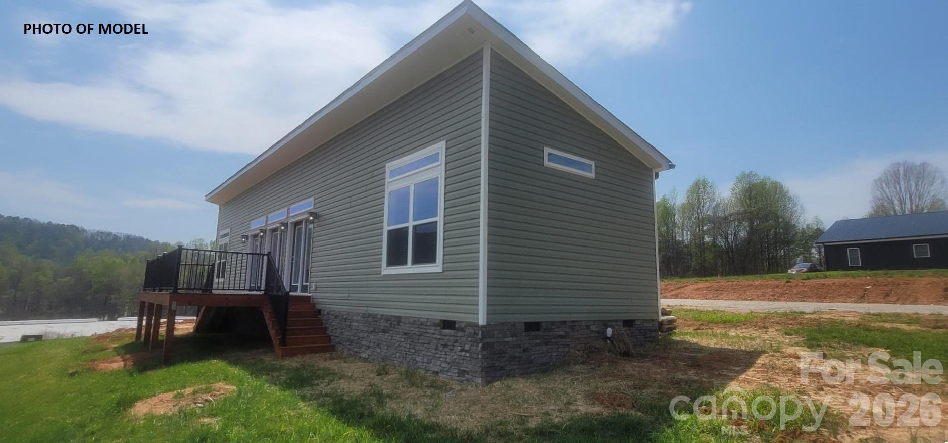 PRE CONSTRUCTION in the charming town of Valdese, North Carolina. Featuring 9-foot smooth ceilings, this open-concept floorplan maximizes space and natural light with transom windows in every room. The home includes 2x6 exterior walls, 2x10 floor joists, and an impressive R38/R19/R30 insulation package for superior comfort and efficiency. Beautiful 9" luxury vinyl plank flooring flows seamlessly throughout. The chef's kitchen boasts a stainless steel appliance package, including a 24 cu. ft. side-by-side refrigerator, glass top range, dishwasher, and microwave. Under-cabinet lighting and a shiplap accent wall add elegant touches. Retreat to the luxurious primary suite, complete with a 4'x6' ceramic rainfall shower. Stay cool and comfortable year-round with the 3-head mini-split HVAC system. Enjoy relaxing summer evenings on the 6'x20' front deck, with a stone foundation adding striking curb appeal. Topped off with 30-year architectural shingles, this home is built to last.