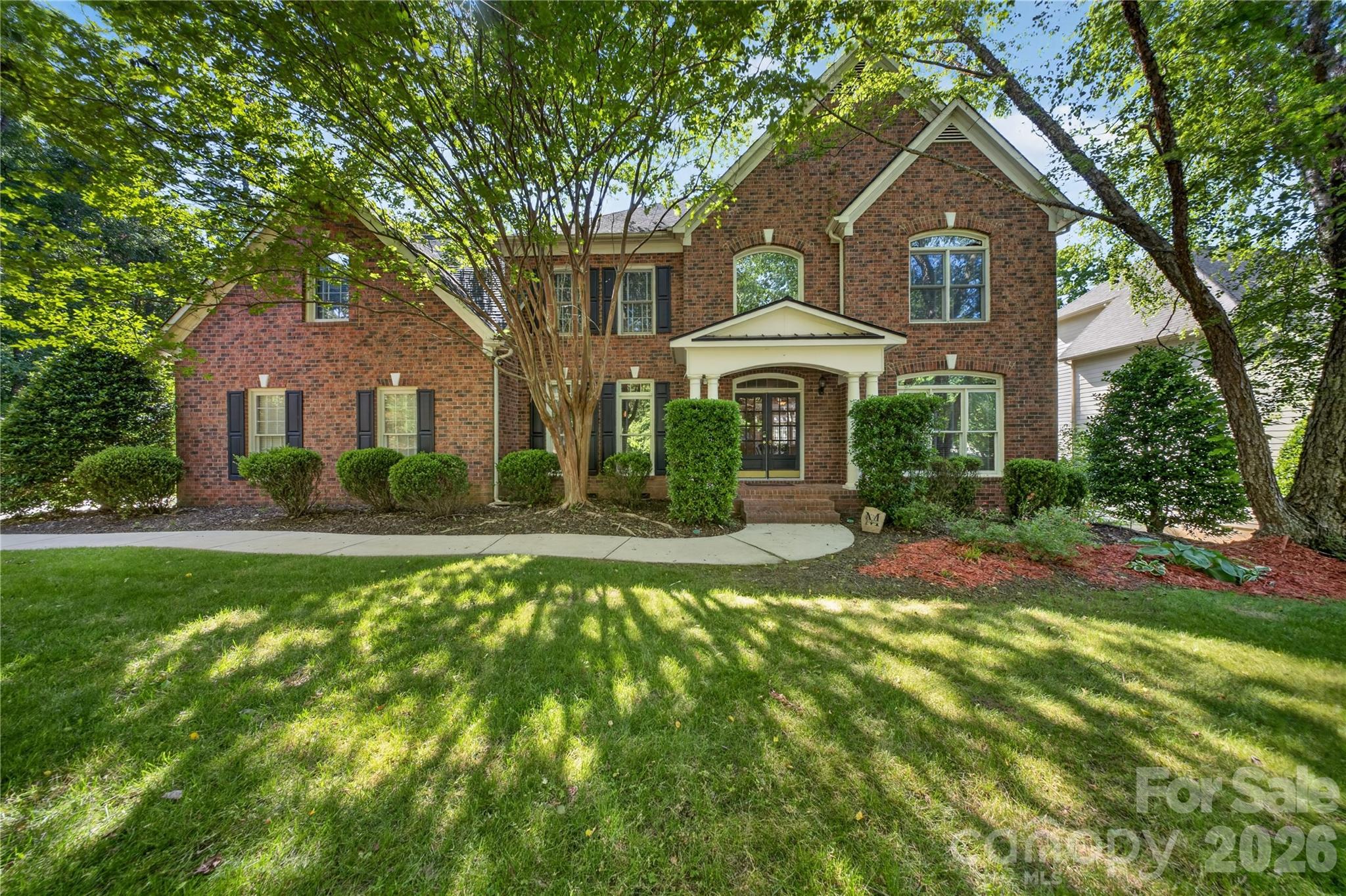 Welcome home to timeless elegance and refined living in the prestigious Lexington community, located in Charlotte’s thriving University area. From the moment you arrive, the home’s stately presence, grand entry, and timeless architectural details create an unforgettable first impression.Inside, an elegant, light-filled interior showcases gleaming hardwood floors, sophisticated formal living and dining spaces, and a thoughtfully designed open-concept layout tailored for both luxurious everyday living and upscale entertaining. At the heart of the home, the chef-inspired kitchen features granite countertops, an expansive breakfast bar, and effortless flow into the inviting family spaces. Architectural distinction continues with dual staircases that lead to a sprawling second level, where generously sized bedrooms are thoughtfully arranged for privacy and comfort. An expansive loft/bonus area offers endless possibilities for a private media lounge, executive office, or refined recreation space.The lavish primary suite serves as a true sanctuary, complete with a spa-inspired bath featuring soaring vaulted ceilings, expansive windows that fill the space with natural light, dual vanities, a deep soaking tub, and a separate glass-enclosed shower designed for ultimate relaxation.The finished walk-up third level expands the home’s luxury appeal 
with a dedicated theater room and private exercise room, offering the perfect blend of entertainment and wellness within your own home.Step outside to your private backyard retreat featuring a sparkling pool, relaxing hot tub, and charming gazebo—an ideal setting for entertaining guests or enjoying peaceful evenings at home. Mature landscaping surrounds the property, while the side-load three-car garage enhances both functionality and curb appeal.Residents of Lexington enjoy an elevated lifestyle with resort-style amenities including a clubhouse, swimming pool, tennis courts, pickleball courts, playground, and picturesque tree-lined streets with sidewalks and charming streetlights.Perfectly situated with convenient access to I-85 and I-485, and just moments from UNC Charlotte, Concord Mills, and Northlake Mall, this exceptional home offers a rare blend of elegance, comfort, and convenience in one of Charlotte’s most sought-after communities.