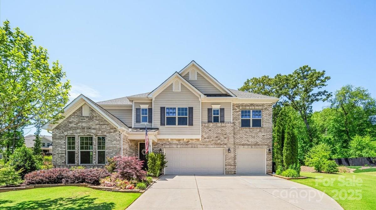 LOWEST PRICE PER SQUARE FOOT IN BENT CREEK! Tucked in a quiet cul-de-sac on one of the largest home sites in the desirable Bent Creek neighborhood, this beautiful home offers privacy with no neighbor to the left and peaceful woods behind. The open floor plan includes a guest suite on the main level, perfect for visitors or multi-generational living. Step outside to a stunning travertine patio featuring a wood-burning fireplace, custom built-in grill, putting green, firepit, and paver patio—an entertainer’s dream! A full irrigation system services all turf and planting beds, including drip lines for added convenience. The spacious 3-car garage provides ample storage. Enjoy resort-style amenities such as a fitness center, outdoor pool, clubhouse, playground, and scenic walking trails. Ideally located near popular dining, shopping, and entertainment in Indian Land and Waxhaw, and zoned for top-rated Indian Land schools. This one checks all the boxes—don’t miss it!