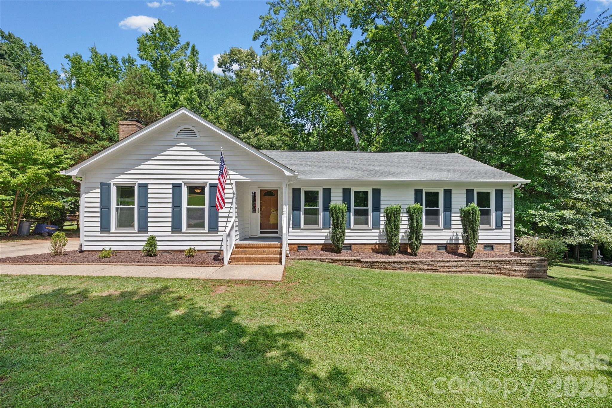 Don't miss this beautifully maintained 3-bedroom, 2-bath ranch gem nestled in an established Fort Mill neighborhood where children still ride bikes, neighbors wave, and life moves at a comfortable pace. Situated on a generous .42-acre lot near a quiet cul-de-sac. This property offers the perfect blend of privacy and convenience with no HOA! Step outside and discover one of the home's most impressive features - a gorgeous backyard retreat!  This area is complete with a spacious deck, storage shed, fire pit area, and a wooded backdrop that can never be developed, providing a peaceful green space after a long day. Inside, you'll find 1,577 square feet of thoughtfully cared-for living space. The kitchen is move-in ready with all appliances conveying, including the refrigerator, washer, and dryer. Additional upgrades include an encapsulated crawlspace for added peace of mind. Whether you're entertaining on the deck, or simply settling into a well-established community, this home offers the comfort & charm you're searching for! Make your appointment today.