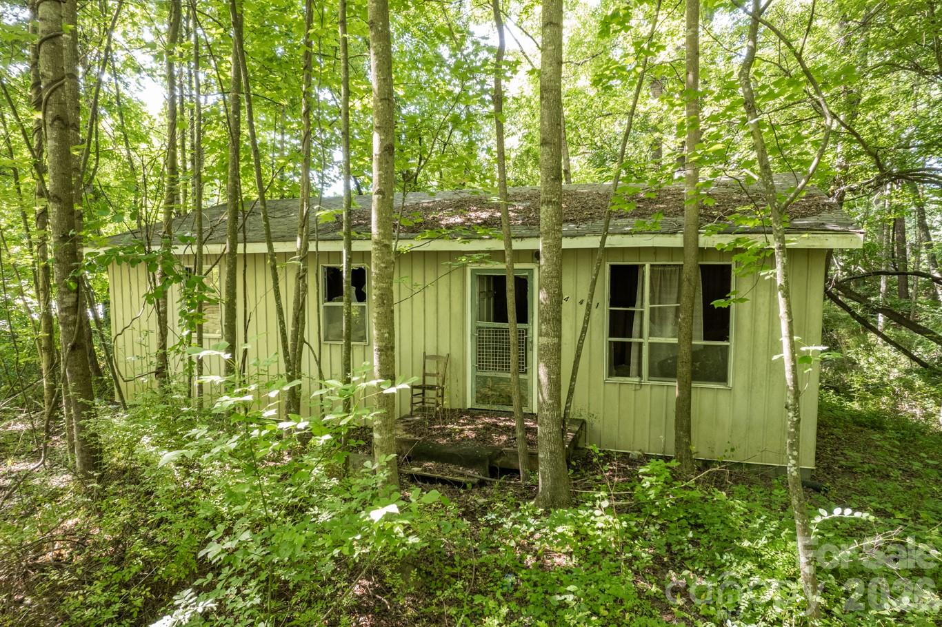 Attention builders, developers, and investors—don’t miss this rare opportunity in the heart of Black Mountain. Tucked away on a quiet, low-traffic street, this private, wooded property is just moments from Lake Tomahawk and the charm of downtown. With public utilities available and short-term rentals allowed, the possibilities here are abundant. Preliminary guidance suggests potential for up to two-three build sites (buyer to confirm), making this an ideal candidate for an investment project. The surrounding area offers an inviting lifestyle with nearby golf, tennis, sports fields, and a thriving downtown filled with beloved restaurants, breweries, coffee shops, and boutiques. Asheville is just a short 20-minute drive away. The existing structure is likely a teardown.