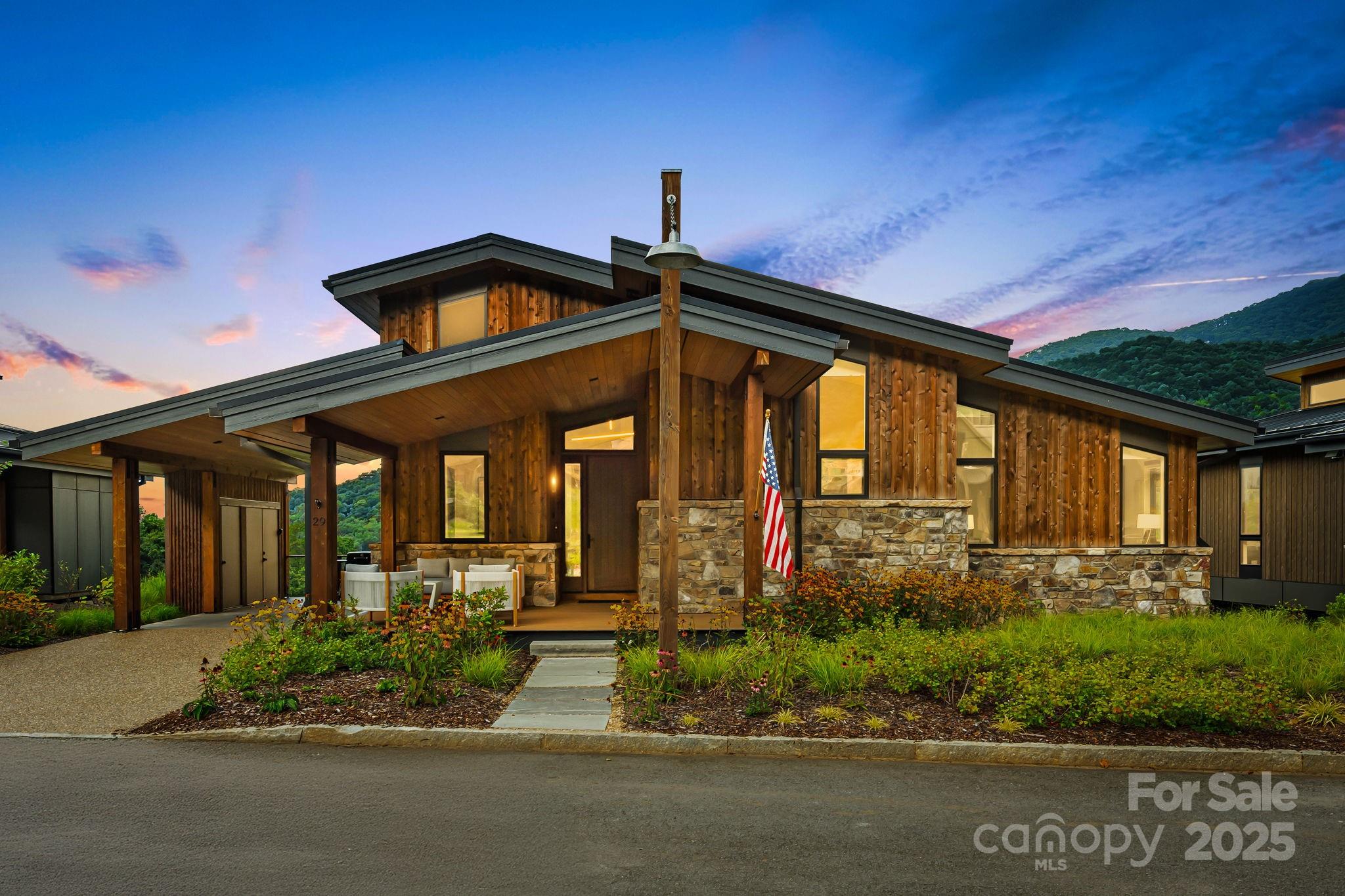 Location, Views and Elevation. Perched on the front row of the desirable Doubletop Village, this home overlooks the gorgeous Palmer Practice Park and the mountains beyond.  Just steps away from the award winning clubhouse at Balsam, you can walk to dinner and enjoy a great evening by the stone village fireplace. If you prefer to travel by golf cart, this is the only community within Balsam that allows you to. At 3,500 feet of elevation, you will enjoy cool summer days as you sit outside and watch the mountains come alive. This incredible home represents the epitome of mountain modern architecture, combining spaciousness and luxury with utmost versatility. Featuring three bedroom suites and a fourth built-in bunk room, it's ideal for entertaining friends and family.  With its clean, natural lines, abundant windows, airy kitchen, white oak flooring, stone gas fireplace, and expansive deck, this home is a perfect fusion of indoor and outdoor living.  For those seeking a lock and leave solution, you won't find anything better. The home is being sold fully furnished for you to enjoy immediately. Balsam Mountain Preserve is a private 4,400 acre club community with 3,200 acres of conservation land and completed amenities featuring golf, equestrian, scenic trails, tennis and multiple dining venues.