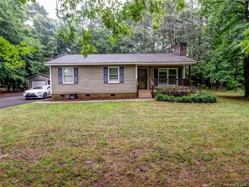 This Charming Ranch Home on Almost an Acre will Not Last Long!  2 Year Old HVAC, Renovated Master Bath, Updated Kitchen and Laminate Hardwoods Throughout is Ready for You!  Check out the Master Bath with Frameless Glass and Tile Shower and Large Walk-In Closet in Master Bedroom. Fabulous Outdoor Living with Lovely Covered Front Porch + Deck Overlooking Private Wooded and Fenced Backyard + Storage Shed. Very Quiet Road and Easy Access to Wesley Chapel Shopping and Target.  Come View Today!