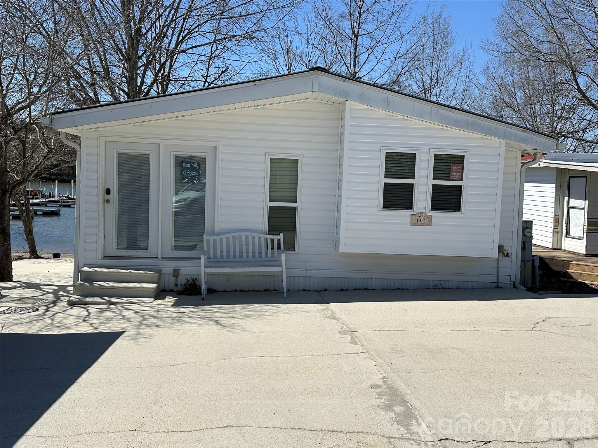 A rare opportunity to own waterfront property in Badin Shores Resort! This park model home is ready for someone to bring their vision and decorating ideas to life. Enjoy wonderful water views from the living area and kitchen, creating a relaxing setting to take in the beauty of the lake. A spacious screened porch stretches across the front of the home, offering the perfect place to unwind while watching boaters launch at the nearby boat ramp or enjoying watching the boats out on the water. The property also features an expansive lakeside yard and a side patio area, perfect for hosting family gatherings, cookouts, and entertaining guests. Inside, the home is ready for updates, presenting a great opportunity to remodel and customize the space. New flooring along with kitchen and bathroom updates would significantly enhance the home's appeal and value. With its prime waterfront location and endless potential, this property is a fantastic chance to create your own lakefront retreat.