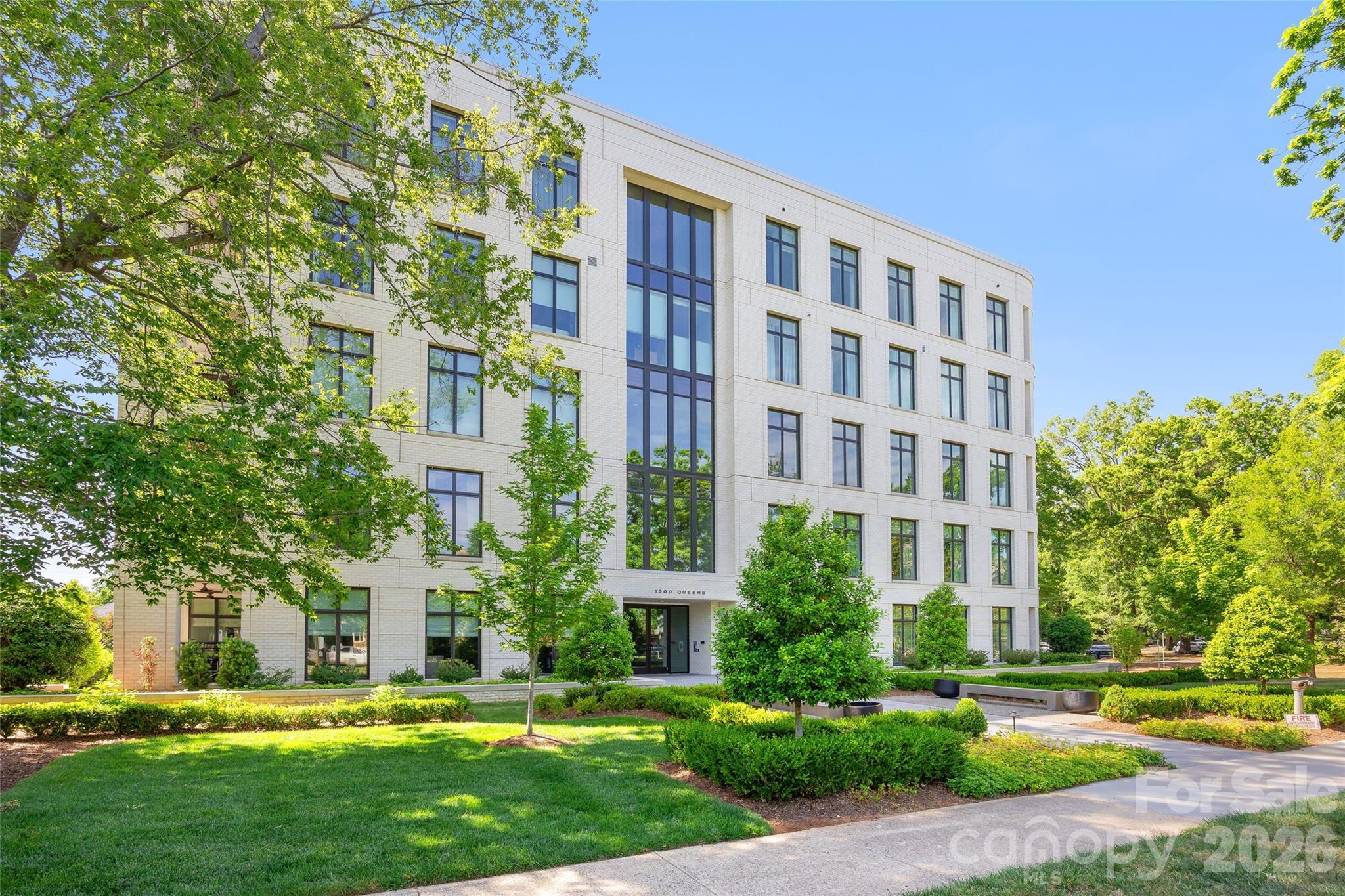 Fabulous condominium at 1500 Queens Road in the heart of Myers Park! Situated on the first floor and elevated from the ground level, this one-level home ensures effortless accessibility and convenience. Stunning home with impeccable high-end finishes throughout including a chef’s kitchen with Sub-Zero refrigerator, Wolf appliances, loads of cabinetry, expansive kitchen island, and wet bar. Much storage throughout including floor-to-ceiling built-in wardrobe and walk-in closet in primary bedroom. Soft-close pocket doors. Custom sunroom with sliding glass doors opening to living room and terrace. Beautiful, covered terrace with gas fireplace. Parking garage with assigned parking spaces and a private storage room. This Simonini-built midrise on the corner of Queens Road and Pembroke Avenue is ideal for those seeking convenient guest street parking as well as easy access to nearby shops, grocery and restaurants.