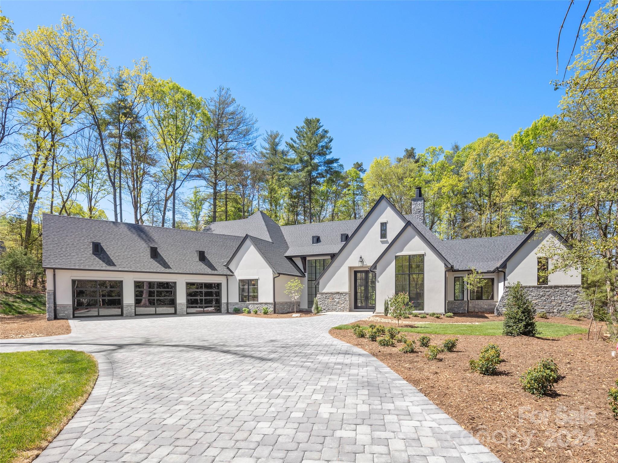 Nestled in The Ramble, one of Asheville’s premier luxury communities, this contemporary new construction home is as stunning as it is special. As you place your hand on the grand entry door, you immediately feel the quality that is synonymous with a Heatherly Construction built home. Stepping inside, your eyes are drawn to the expanse and beauty of this open concept floor plan with one level living. Abundant light fills the two-story great room through the large windows and sliding doors that open onto your beautiful and private covered porch that practically doubles your entertainment space. From the fantastic chef’s kitchen to the exceptionally well-appointed primary bedroom en-suite, you are enveloped by high-end finishes and the latest in smart technology. This home boasts three additional en suites, large walk-in pantry, and office. Near walking trails and the Living Well Center you are close to everything, yet you feel like you are tucked far away in your own secluded oasis!