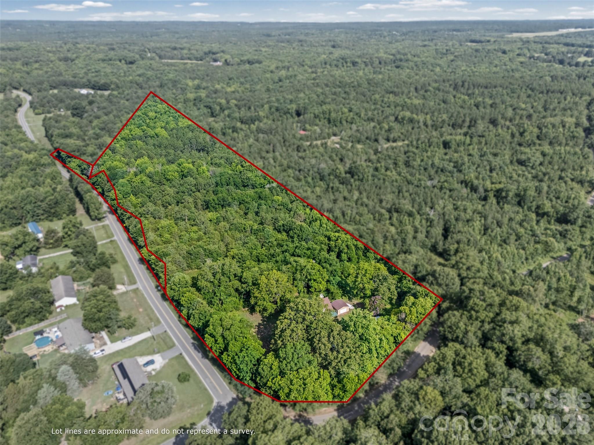 Rare opportunity to own two parcels totaling approximately 14 wooded acres in Chester, SC. Offering privacy, valuable road frontage, and subdivision potential, this property is ideal for investors, builders, or those seeking a private family compound. Enjoy the peaceful setting and a chance to renovate this 1922 home while remaining conveniently located near local stores. The surrounding area is not currently planned for future development at this time, preserving the rural character and privacy of the property.
The property includes electricity on site, a dug well (in need of repair), and a septic system believed to be present. Also located on the property is an approximately 1,468-square-foot, 1.5-story home that has been completely gutted and will require total reconstruction. Windmill present and believed to be restricted by vines currently. No value has been assigned to the home in the pricing. Roof is believed to be approximately 8 years old. Additional improvements include two metal roll-up door garages on concrete pads and multiple storage sheds. Lumber in the structure will convey with the property. 
Whether you’re looking to renovate, build new, create a multi-generational retreat, subdivide, or develop your vision from the ground up, the possibilities are extensive. Property is being sold strictly AS-IS. Enter structures at your own risk. Buyer and buyer’s agent to verify all information important to them, including acreage, subdivision potential, utilities, septic system, and condition of improvements. Please do not enter property without an appointment. Driveway is at the corner of Minter and Hosea Strong.

Close to Chester Golf Club, Yoco border, and Rockhill! 
* Being sold AS-IS