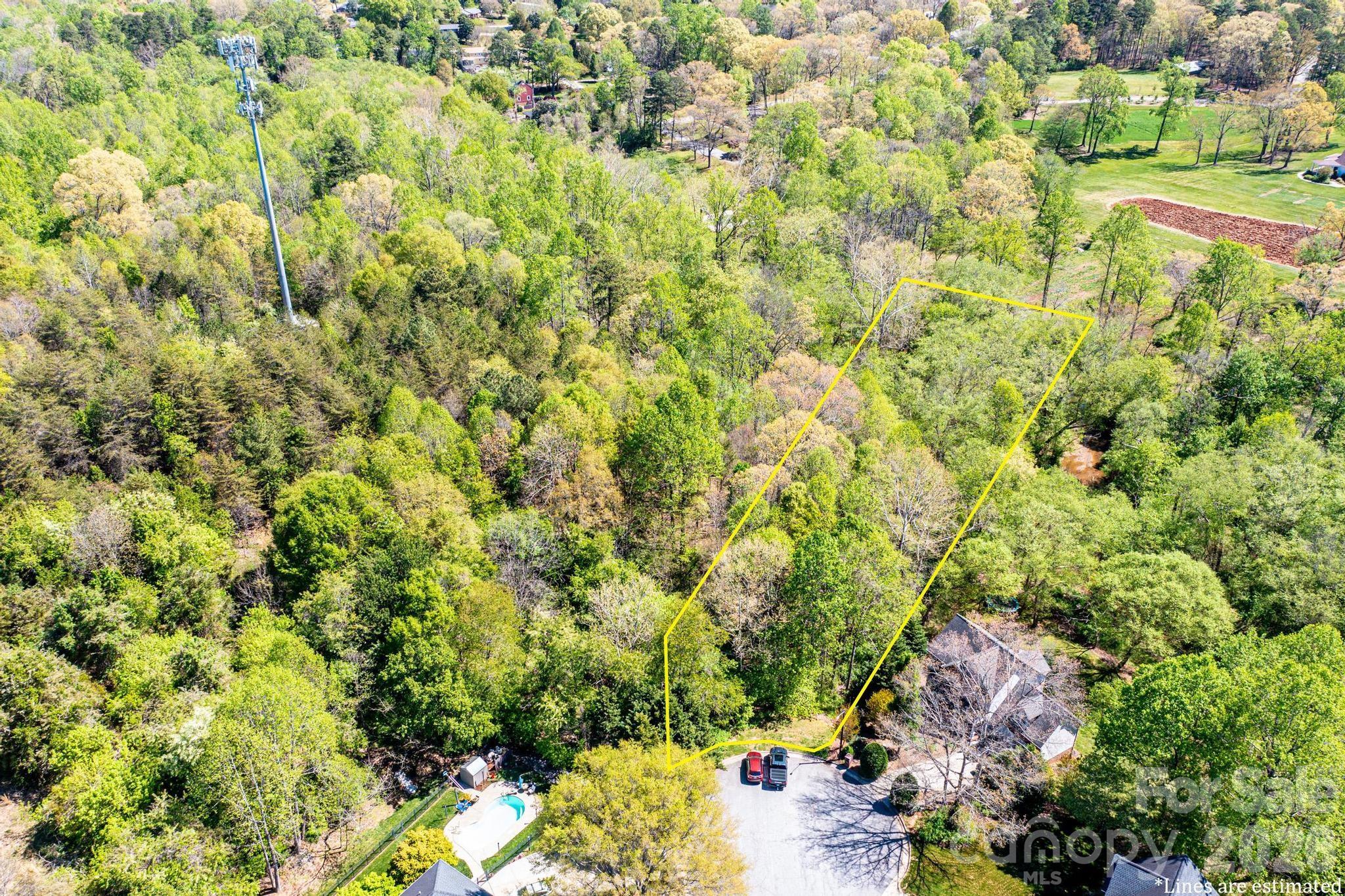 Experience the best of both worlds—wooded tranquility and city accessibility—in one of Hickory’s most established neighborhoods. Over One Acre on Falling Creek. The lot features city water and sewer availability, along with underground utilities and natural gas. With a manageable 1,500 heated square foot minimum for one story build requirement, this property is ideal for a variety of architectural styles; 2000 sqft for 2 story.  Low HOA dues ($120/yr).