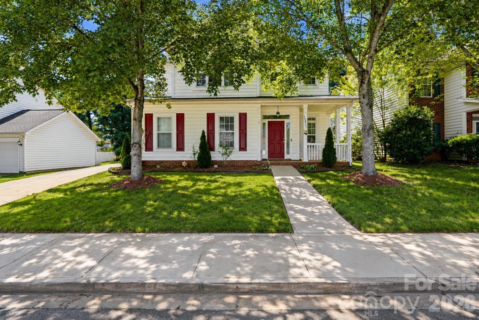 Welcome to this beautifully maintained 4-bedroom, 2.5-bath home located in the Stone Hollow community of Huntersville, NC. Situated on a spacious lot with exceptional curb appeal, this home features a charming covered front porch, side-load two-car garage, and extended driveway that offers both style and functionality.
Step inside to discover a bright, open-concept floor plan designed for comfortable everyday living and effortless entertaining. The spacious living and dining areas are connected by a stunning double-sided fireplace, creating a warm and inviting atmosphere throughout the main level.
The light-filled kitchen offers granite countertops, abundant cabinet storage, generous prep space, and included appliances — perfect for cooking, gathering, and hosting. This move-in-ready home has also been updated with new luxury vinyl plank (LVP) flooring throughout both the main and upper levels, combining modern style with durability and low-maintenance living.
Upstairs, you’ll find all four bedrooms, a full secondary bath, and a conveniently located laundry room. The oversized primary suite serves as a private retreat featuring dual closets and a spa-like en-suite bath complete with dual vanities, a soaking tub, and separate shower.
Step outside to your own private backyard oasis. The fully fenced yard is beautifully landscaped with mature fruit trees and lush greenery, creating the perfect setting for relaxing evenings, gardening, play, or entertaining guests.