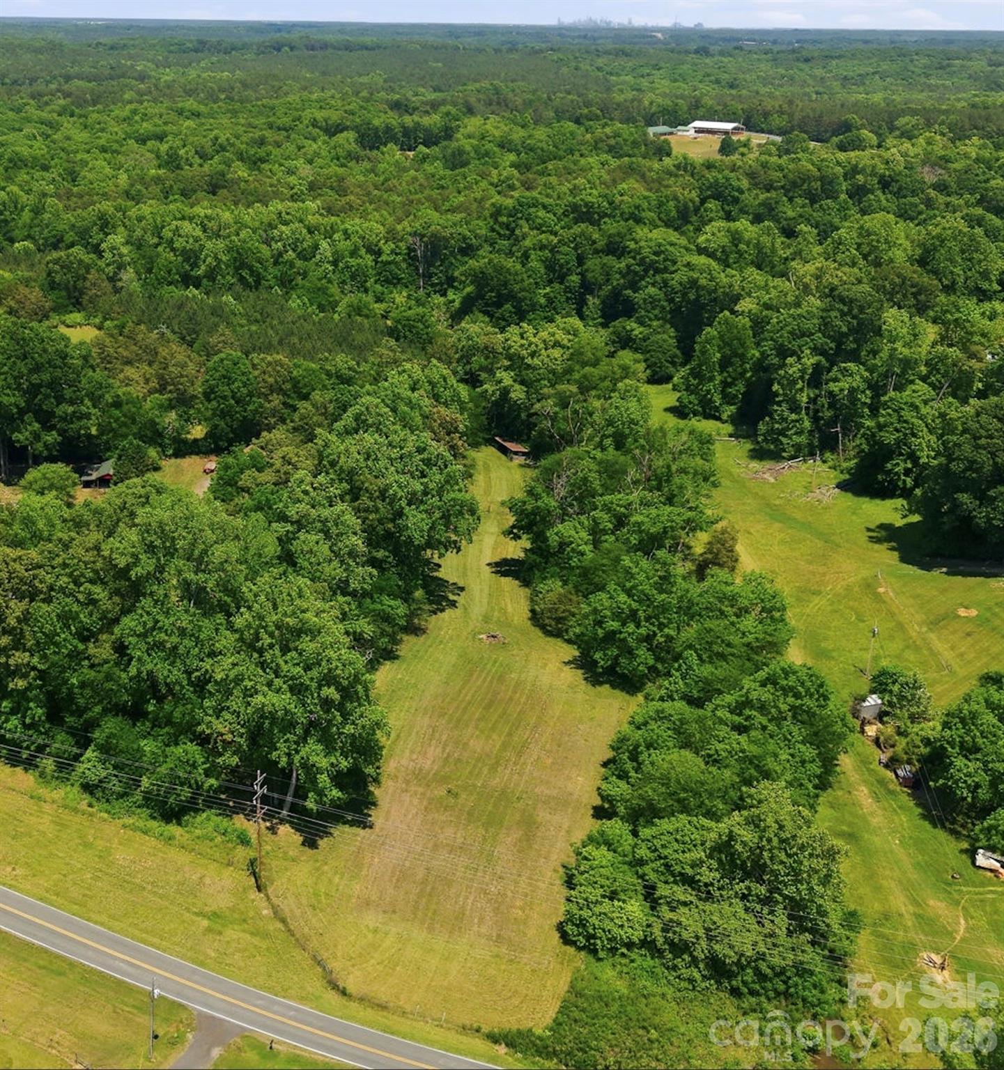 Lot 3 Rufus Ratchford Rd – Beautiful 2.58-Acre Homesite Near Lake Wylie

Discover the perfect blend of privacy, convenience, and opportunity with this gorgeous 2.58-acre lot near Lake Wylie. The property offers an ideal setting for your dream home, hobby farm, or future investment. A natural border of mature trees surrounds the land, creating a peaceful country atmosphere while still providing an open and build-ready homesite.

Enjoy the freedom of no HOA restrictions and plenty of space to build, expand, and live the lifestyle you want. The main buildable area of the property is already mostly cleared and level, helping reduce preparation costs and making it easier to begin construction. An existing utility shed is located at the rear of the property and already has water and electricity in place, adding immediate functionality and value.

With potential for future commercial rezoning, this property also presents an exciting opportunity for investors or business-minded buyers seeking flexibility in a rapidly growing area.

Conveniently located between Belmont, Lake Wylie, Clover, and Gastonia, this property offers the perfect balance of peaceful country living and everyday convenience. Just minutes from Lake Wylie, shopping, restaurants, Walmart, Lowe’s, Starbucks, grocery stores, and major commuting routes, the location provides easy access to everything while still maintaining privacy and space.

This rare property combines tranquility, accessibility, and long-term potential in one of the area’s fastest-growing regions.