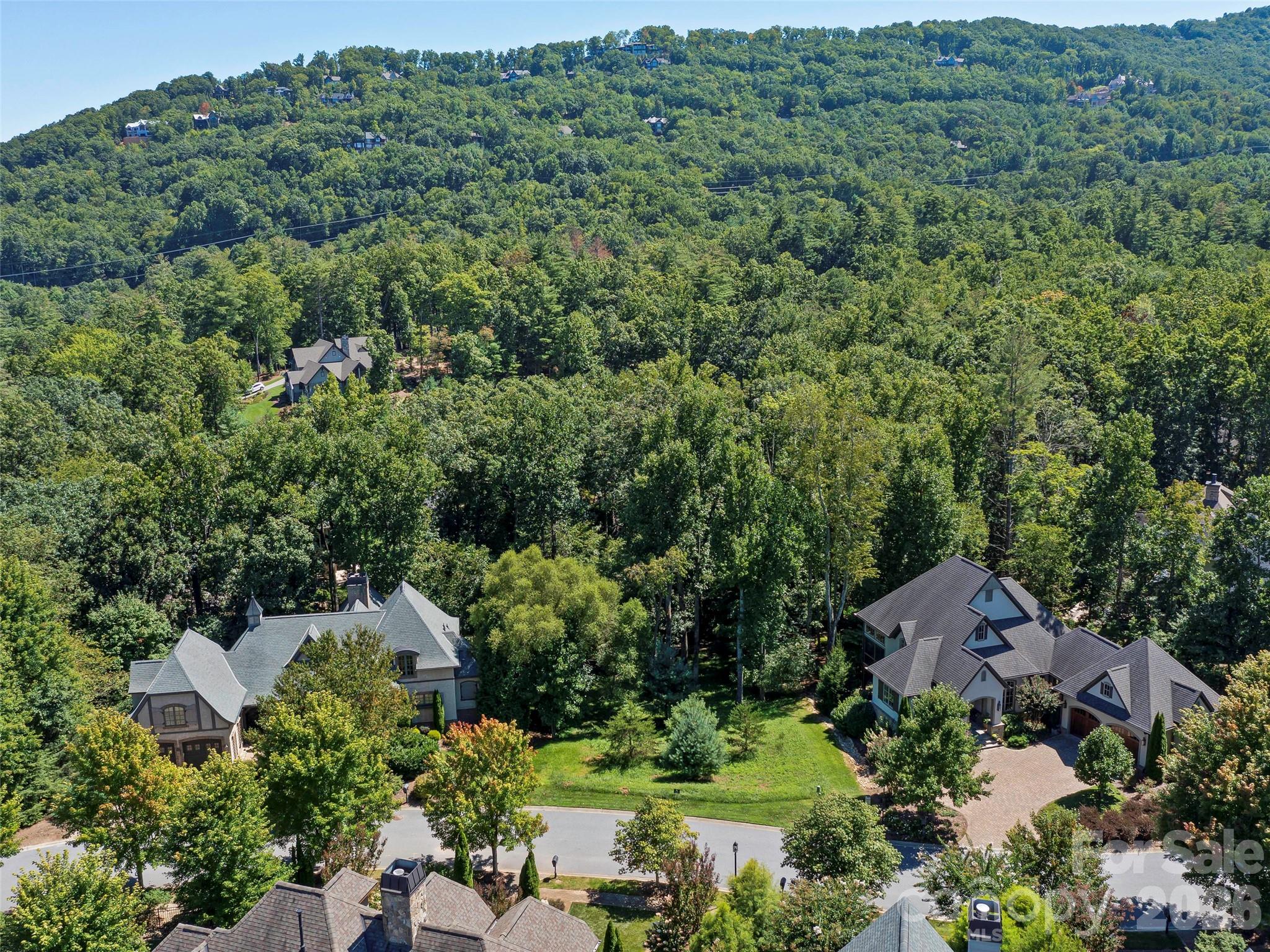 A rare opportunity awaits with the final homesite in Cove Park that can accommodate a lower-level walkout. Nestled within The Cliffs at Walnut Cove, this property overlooks a peaceful stream and adjoins protected green space, with direct access to five miles of scenic trails just steps from your backyard. Walk to the 18,000 SF state-of-the-art Wellness Center or take a short drive to the Jack Nicklaus Signature Golf Course and Tavern. A Cliffs membership provides access to all seven premier communities and their world-class golf. Ideally situated between Asheville and Hendersonville, minutes from the Blue Ridge Parkway and just seven miles from Asheville Airport, you’ll enjoy proximity to fine dining, boutique shopping, and endless outdoor recreation. Partner with one of our preferred builders to bring your vision to life or explore the custom home concept designed by Gabriel Builders—and begin your mountain lifestyle today.