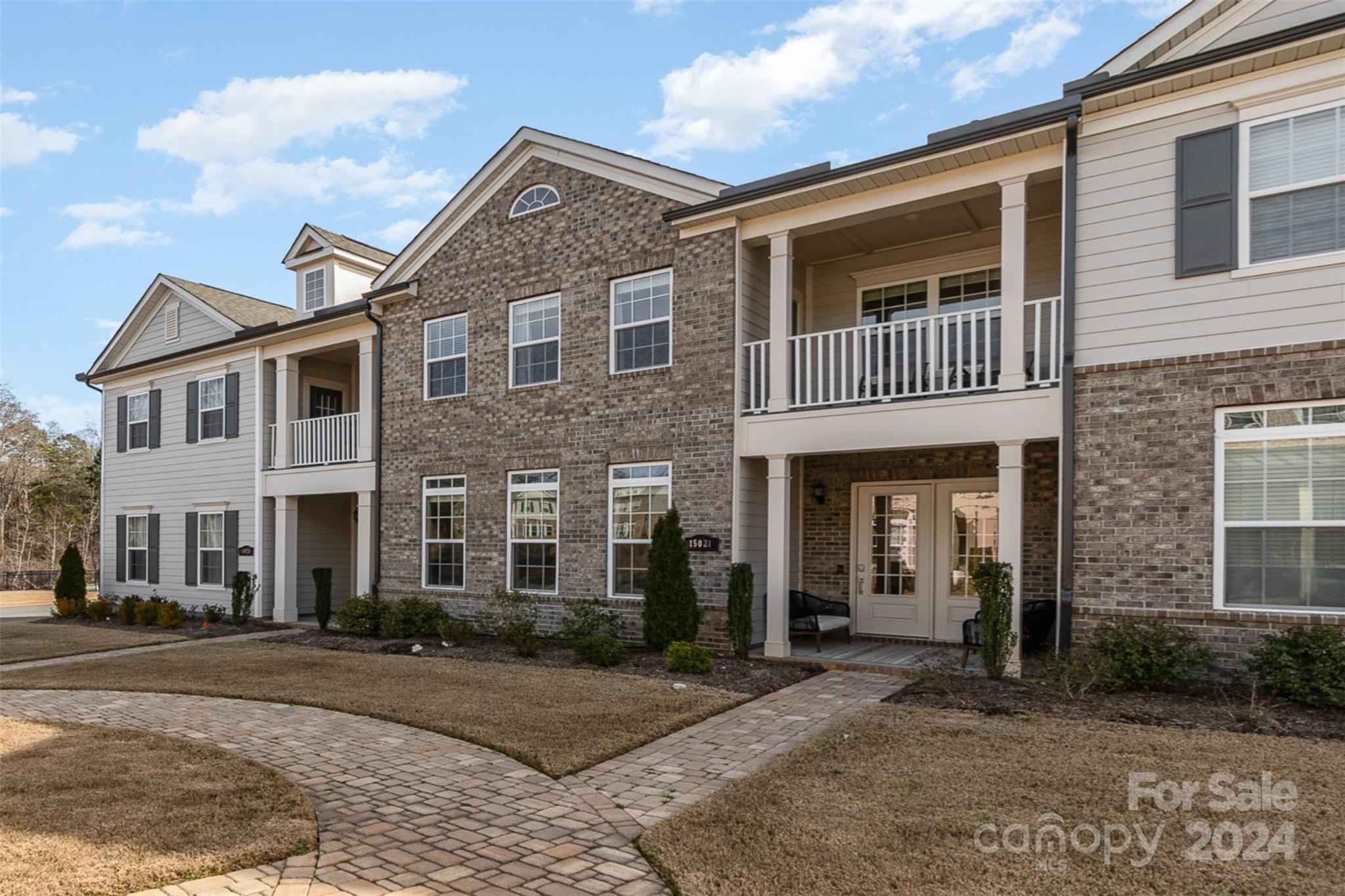 Beautiful move-in ready 3BR townhouse in desirable Providence Village neighborhood, located behind the popular multi-use community of Waverly. Beautiful hardwoods throughout the main level. Gourmet kitchen includes large center island with quartz countertops & plenty of bar seating! A 5-burner gas range, wall oven/microwave, plenty of cabinet space, walk-in pantry with custom shelving make this the perfect space for the chef! All of this opens to the naturally-lit great room with gas fireplace for the perfect entertaining space! You can also enjoy your morning coffee or evening beverage on your covered front porch. Upstairs has a large en-suite with a sitting area, tray ceiling, covered balcony and 2 separate walk-in closets. Both secondary bedrooms have their own bathrooms & walk-in closets. Convenient 2nd-floor laundry room. Walking distance to shops & restaurants. Easy access to I-485 for commuting to Uptown or Airport. Award-winning schools! 2-car garage. Maintenance-free living!!