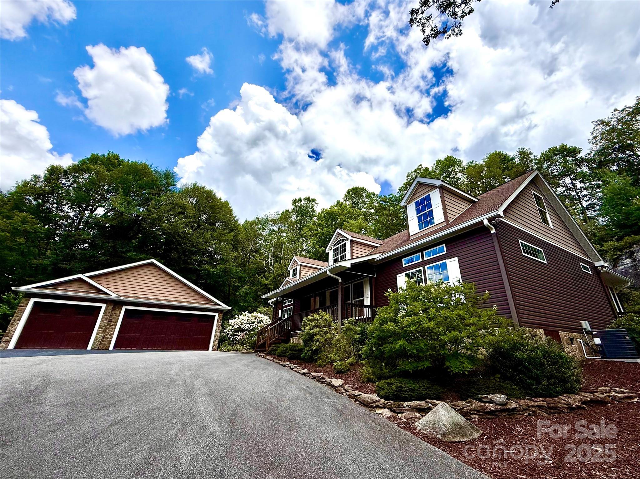 This absolutely stunning & exceptionally maintained 3 BR, 2 Bath cottage w./ oversized 3 car garage & paved driveway is exactly the mountain retreat you are looking for! Wooded serenity abounds in this peaceful private oasis in sought after Gingercake Acres. Updated kitchen w./ stainless steel appliances, gas range, custom cabinetry w./ tons of storage space & tile floor (fridge, washer & dryer incl). Large primary retreat w./ en-suite bath w./ dual vanity, 2 showers & tub, tile floor & walk-in closet. Spectacular new great room (2024) w./ wood-burning fireplace, mini split system, vinyl plank & tons of windows complete the package. Rocking chair front porch w./ views of Long Arm Mtn, large walk-up attic w./ expansion possibilities (plumbed for bath) & hardwood floors. This hidden gem is close to Sugar Mtn, Banner Elk & Morganton w./ tons of skiing/shopping/dining/adventure opportunities in the area. Hiking trails in Linville Gorge Wilderness, Pisgah Forest & the Blue Ridge Parkway!
