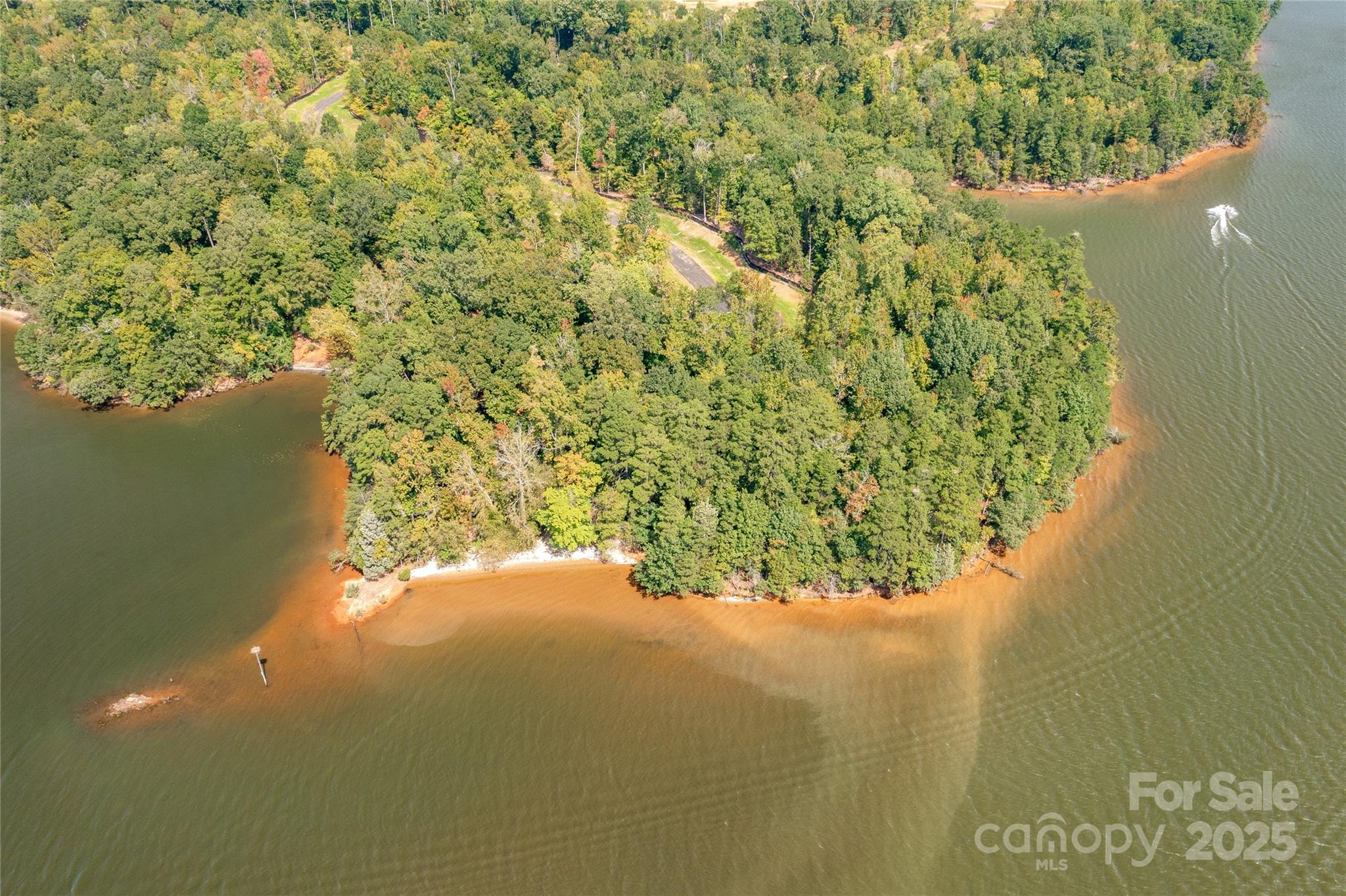 Waterfront homesite in McLean South Shore in Belmont NC on Lake Wylie. Homesite 26 at 1220 Great Egret Drive, Clover SC is a spectacular waterfront point homesite located on the main channel facing south. The homesite catches west and east views as well! An incredible homesite indeed! McLean South Shore offers walking trails, clubhouse, outdoor pool, fitness center, playground. Drift restaurant within walking or golf cart distance. The Carolina Thread trail along Lake Wylie located across New Hope Road. Within minutes of grocery shopping - Publix and Harris Teeter. Plus minutes from the walkable City of Belmont with its quaint vibe, festivals, park, playground, active train line - kids love watching the train, restaurants and shopping. The bustling Charlotte Douglas airport is about 15 minutes away for easy travel access. Uptown Charlotte, South Park and Ballantyne are commutable via nearby highways. Great small town location at doorstep of a bigger city! Premier waterfront community!