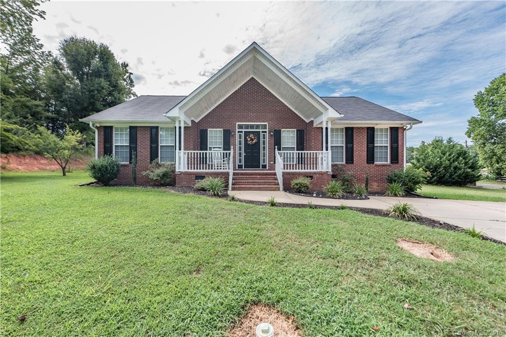 An all brick house with new roof (2016) in heart of town. Stainless steel appliances, granite counter tops, hood, tile back splash with vaulted ceiling in Kitchen and separate breakfast dining area.  Split floor plan with hardwood floors in bedrooms and family room.  Large family room with vaulted ceilings. Large extra room with washer dryer hooks ups, tile floor and large pantry. Two outbuildings sheds, artist shed has electricity and heating/cooling. One of the larger lots in the neighborhood.