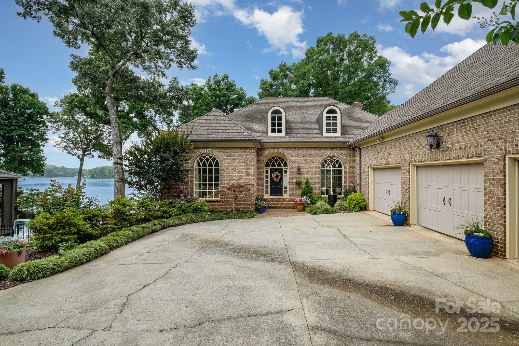 Your Private Lake Norman Oasis Awaits!  Now is the perfect time to make this exceptional waterfront retreat your own. Just 20 minutes from Charlotte & only 3 miles from vibrant Birkdale Village, this rare gem offers over an acre of beautifully landscaped privacy with sweeping open-water views of Lake Norman. Tucked away among mature trees, this serene property invites you to relax and unwind. Take in breathtaking sunsets from your covered private dock, entertain on the expansive Trex deck, or enjoy a peaceful morning on the screened porch with the sounds of nature all around. Inside, a thoughtfully designed open-concept floor plan maximizes the stunning lake views while filling the home with natural light. There’s plenty of space to spread out, with three generously sized bedrooms, updated bathrooms,  a large fourth room that could easily be converted into a bedroom with a city sewer connection (available), and an additional bonus room upstairs perfect for a home office or guest space