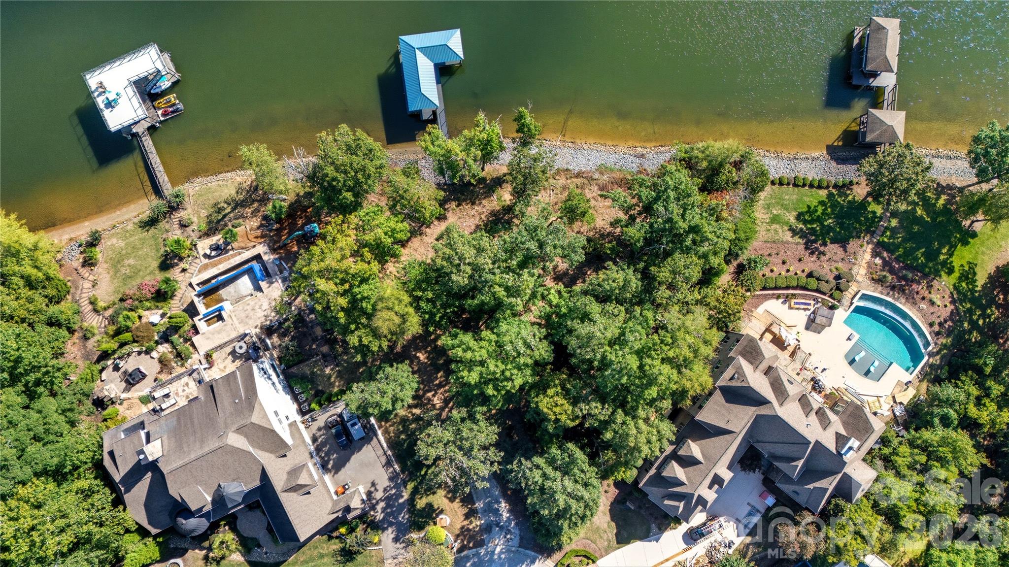 Dreaming of a true waterfront build? This wooded cul-de-sac lakefront lot in coveted Handsmill delivers the wow factor—deep water, sweeping lake views, and excellent frontage. The newer metal-roof dock is ready for weekends on the water while you plan and build your custom home. Enjoy the lifestyle Handsmill is known for: gated entry, luxury clubhouse, pool, marina, and community amenities designed for lake living. Minutes to everyday conveniences and a short drive to Charlotte.