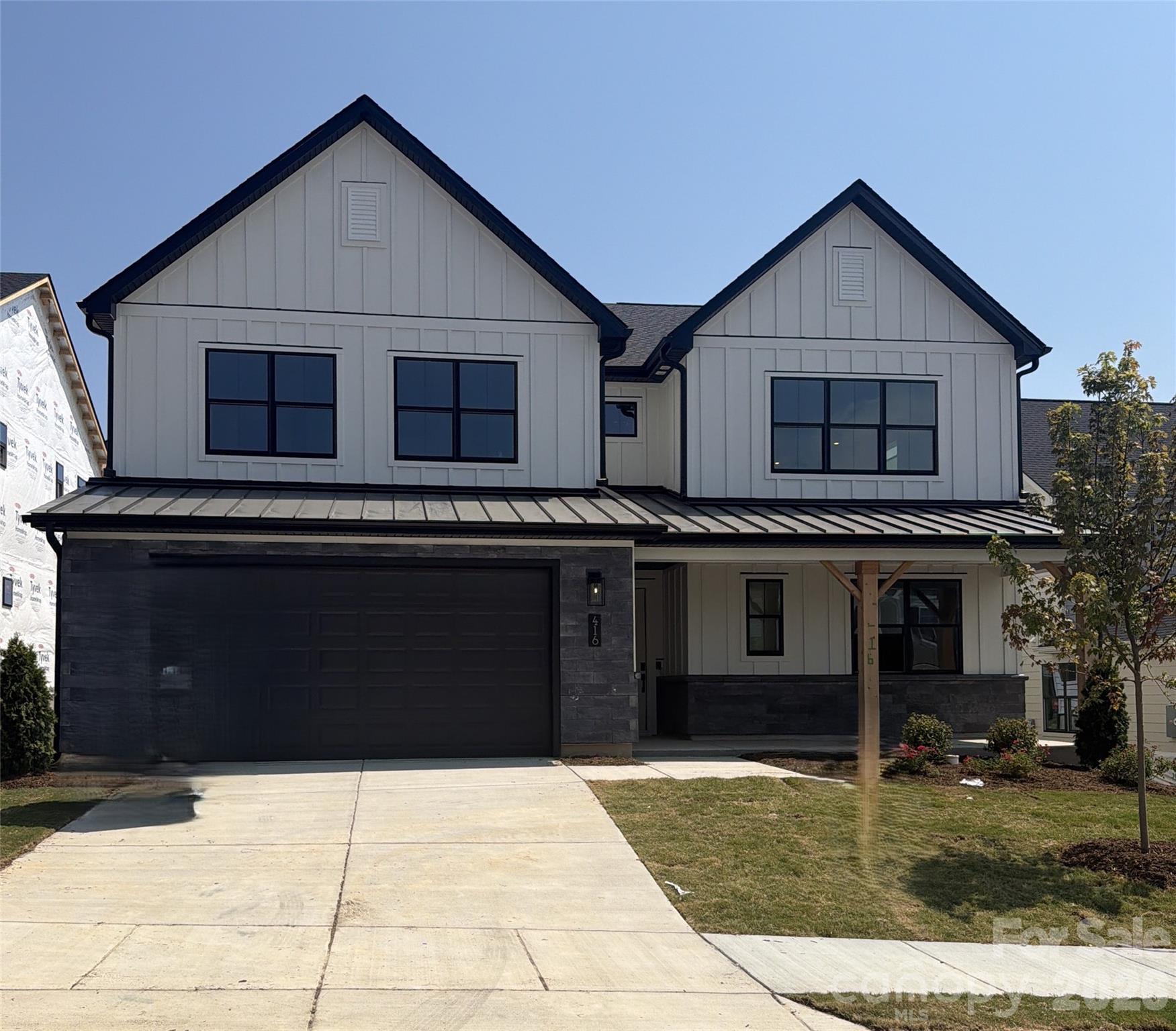 Only 5 homes remain in Windell Woods—don't miss your chance to own our most popular floorplan! This stunning Logan plan showcases a charming modern farmhouse exterior and thoughtfully designed indoor-outdoor living with a covered front porch, covered rear patio, and a private two-story deck off the luxurious primary suite. Inside, you'll find designer-selected upgrades throughout, including quartz countertops, upgraded cabinetry, stainless steel appliances with a gas cooktop, wall oven, canopy hood, and stylish backsplash. The spa-inspired primary bath offers a tiled walk-in shower with glass enclosure and rain shower head for a true retreat experience. Enhanced with upgraded hard-surface flooring and elegant tile in every bath and the laundry room, this home perfectly blends comfort, style, and functionality. With inventory nearly sold out in Windell Woods, schedule your tour today and secure one of the final opportunities to call this sought-after community home!
