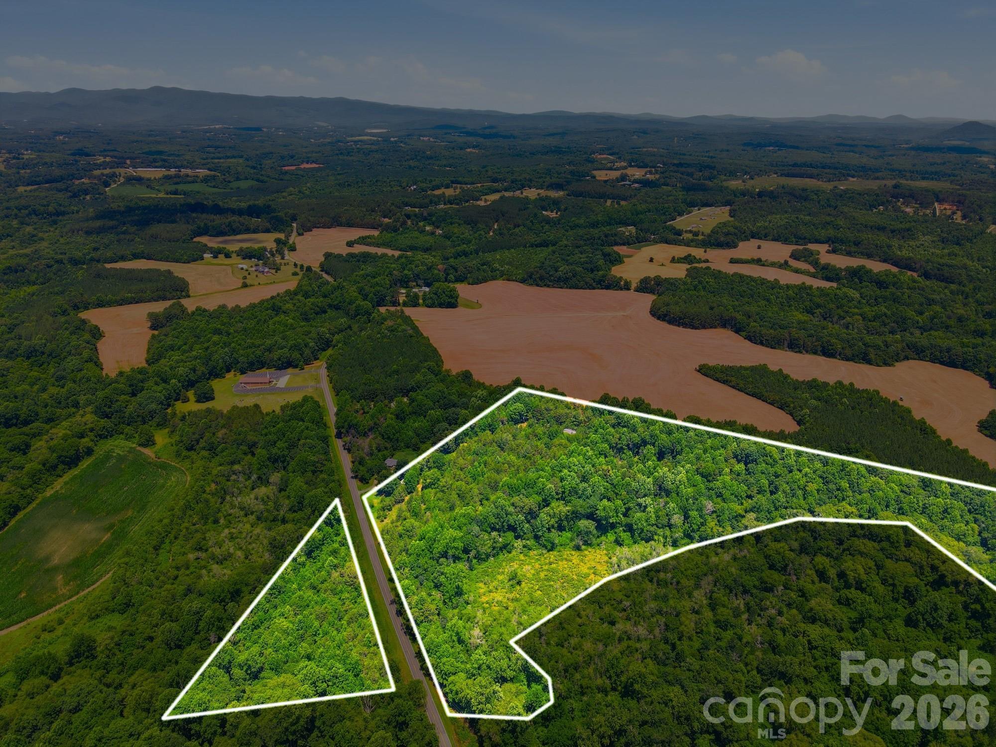 With just under 21 acres of beautiful wooded secluded land 19.74 of those acres offers 2 subdivided lots. In addition to this subject property offers 2 different road frontage access with a part of land being across the street from each other (approx. 795ft of frontage on one side, and approx. 681ft of frontage on opposite side). There is an additional 0.76 acres for the 2nd parcel of land. This is a wooded lot that offers abundance of privacy as portion of land tucks away. You can build your dream home and have the potential of subdividing for multiple homes. This is a perfect opportunity to acquire this land as the city of Lawndale continues to grow. Subject is surrounded by farmland and offers a rural country lifestyle setting. Knob creek borders a couple areas of the land and runs along 2nd parcel of land (PID#63790 0.76 acres). There is an existing structure on the property being a manufactured home that was connected to well water & septic. County water appears to be available. Current owners are unaware of condition of the existing well and septic system. Buyer agents welcome. Agents, please see agent remarks for pertinent details!!
