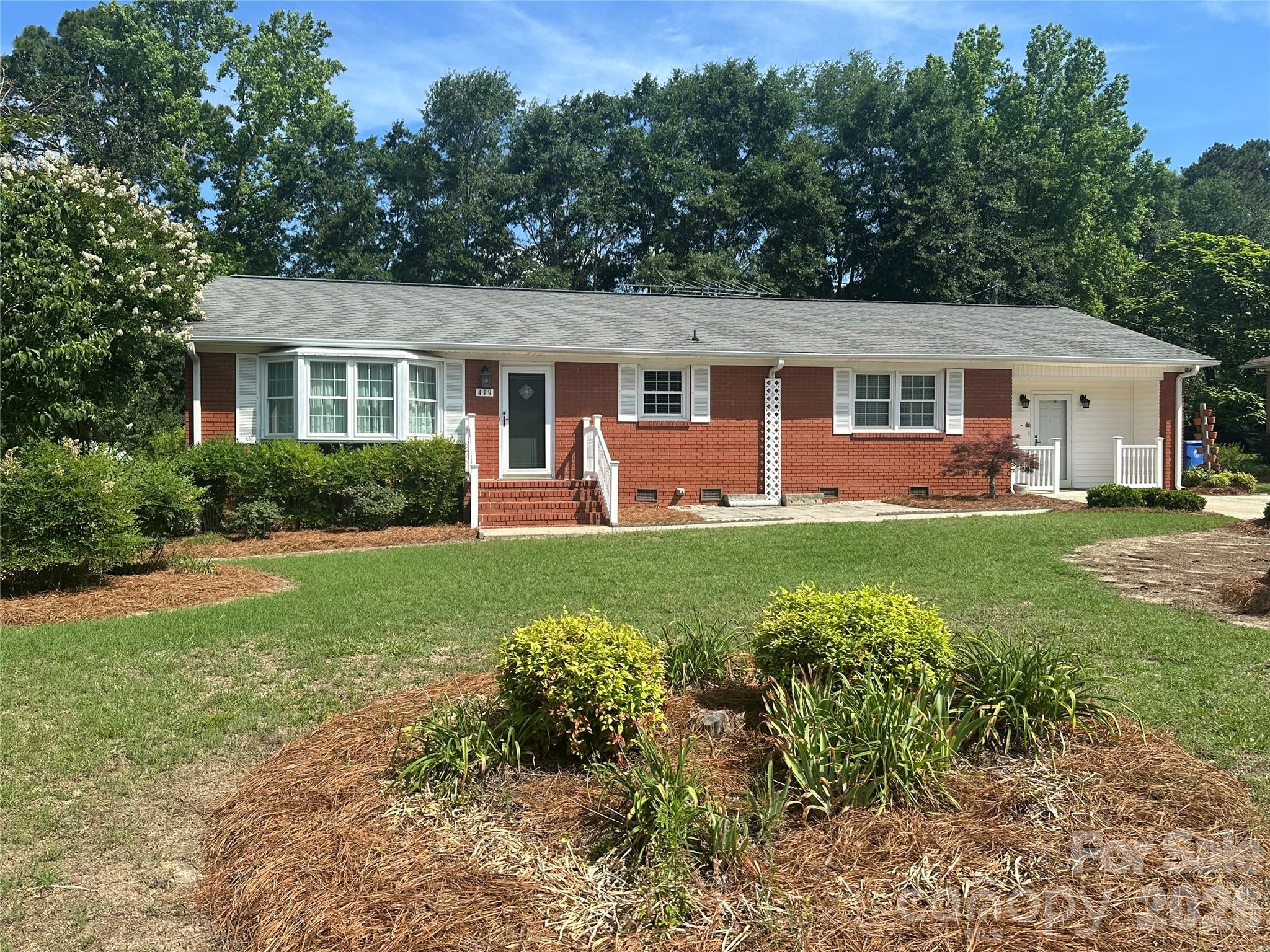 Make this attractive brick ranch your home, with some updates or move right in!  It is situated on a .32 acre lot that is located in an established Pageland neighborhood, within easy access to all area amenities. The bay window in the large living room allows for lots of natural sunlight. The open concept den/dining and adjacent kitchen area with lots of cabinet space and moveable island, is a great place to gather or relax. The primary bedroom has a ceramic tiled ensuite bathroom and walk in closet.  The other two bedrooms are situated for easy access to the full hall bathroom. Enter the mud room/laundry room directly from the concrete driveway/parking area. There is plenty of storage in the back yard.